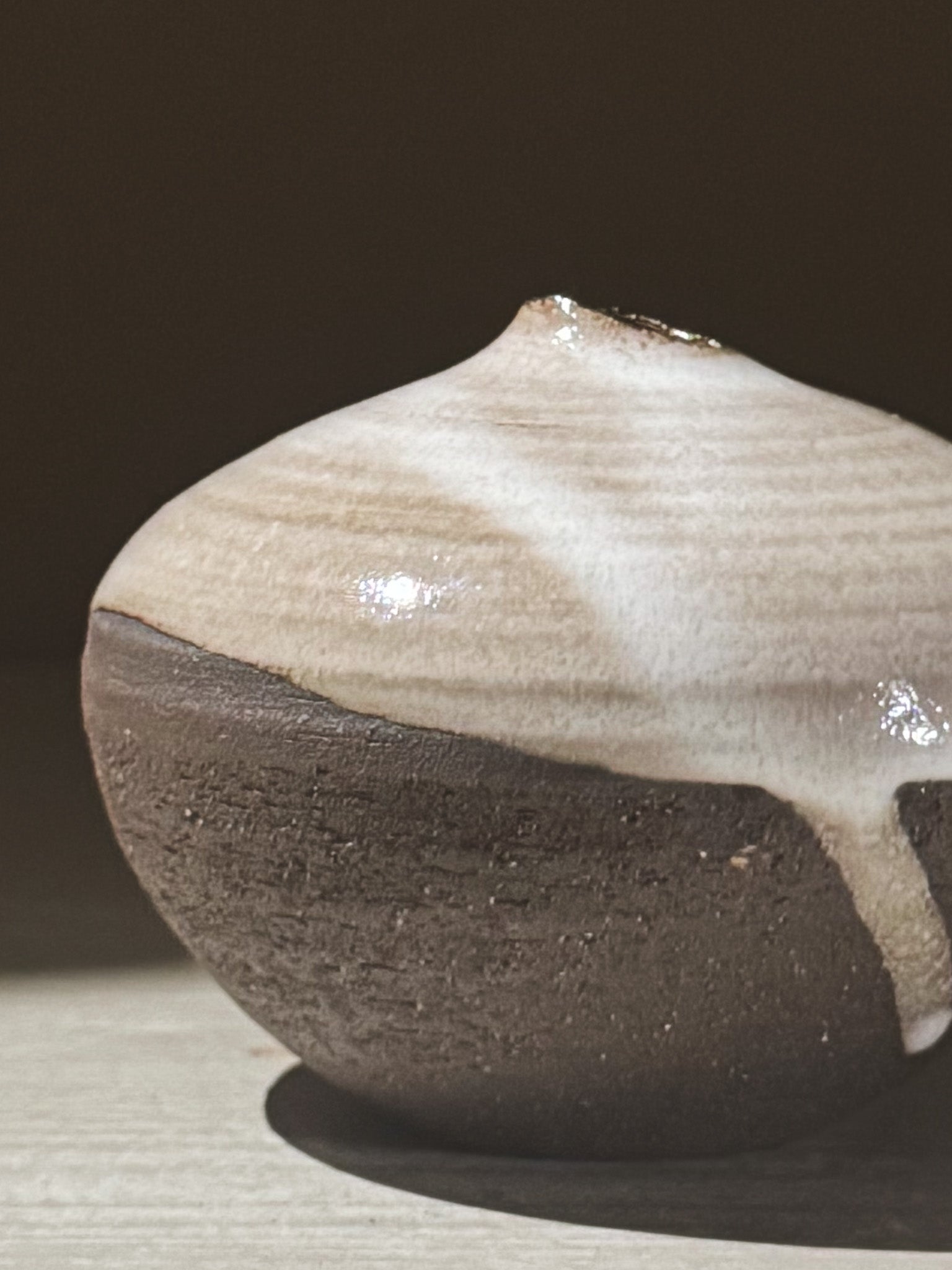 Orb Vase – Yuki Black #11 with unique glaze patterns and a rounded form, showcasing its sculptural presence.