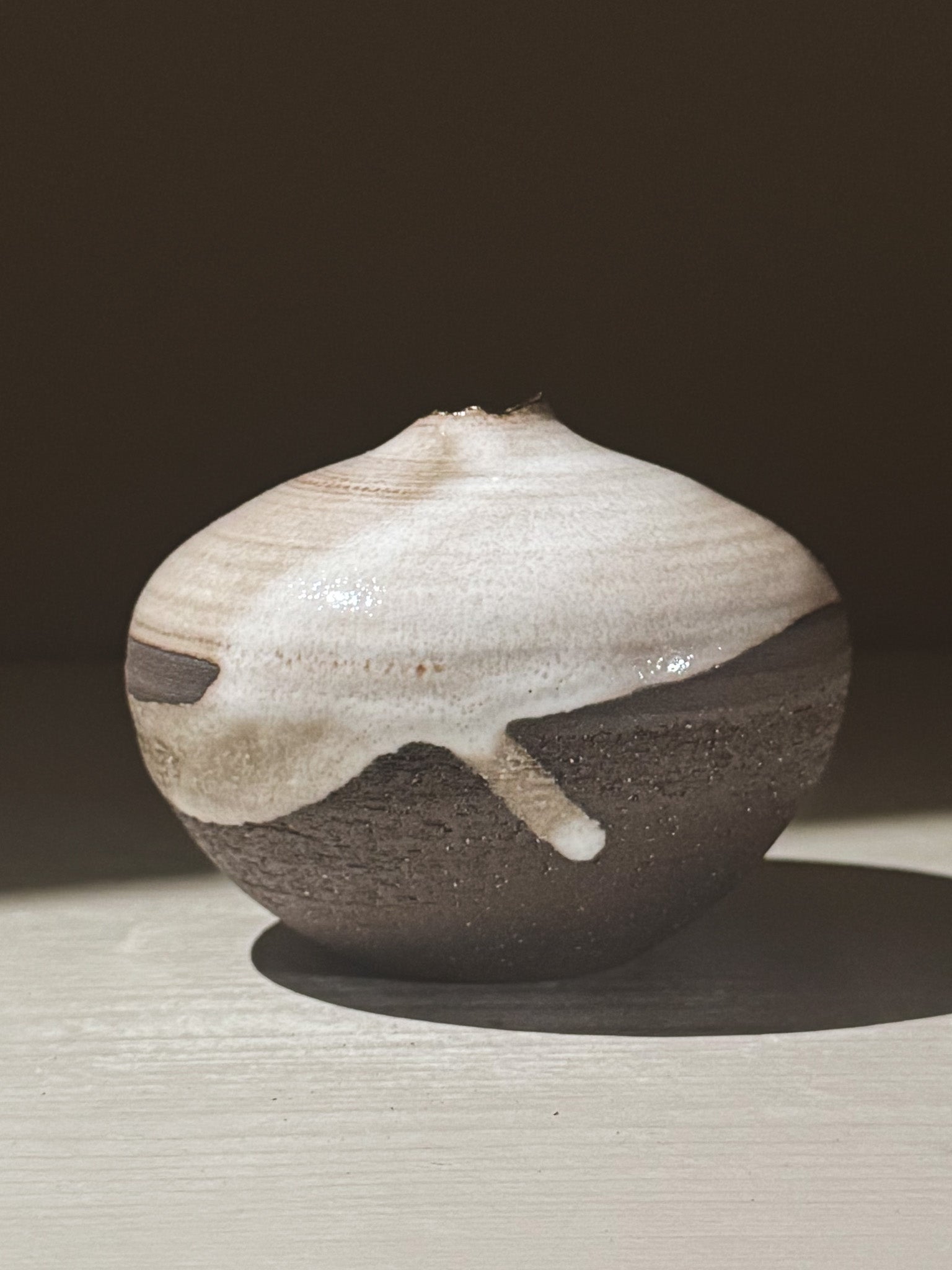 Orb Vase – Yuki Black #11, a unique rounded ceramic vase with organic glaze patterns and a soft sculptural design.