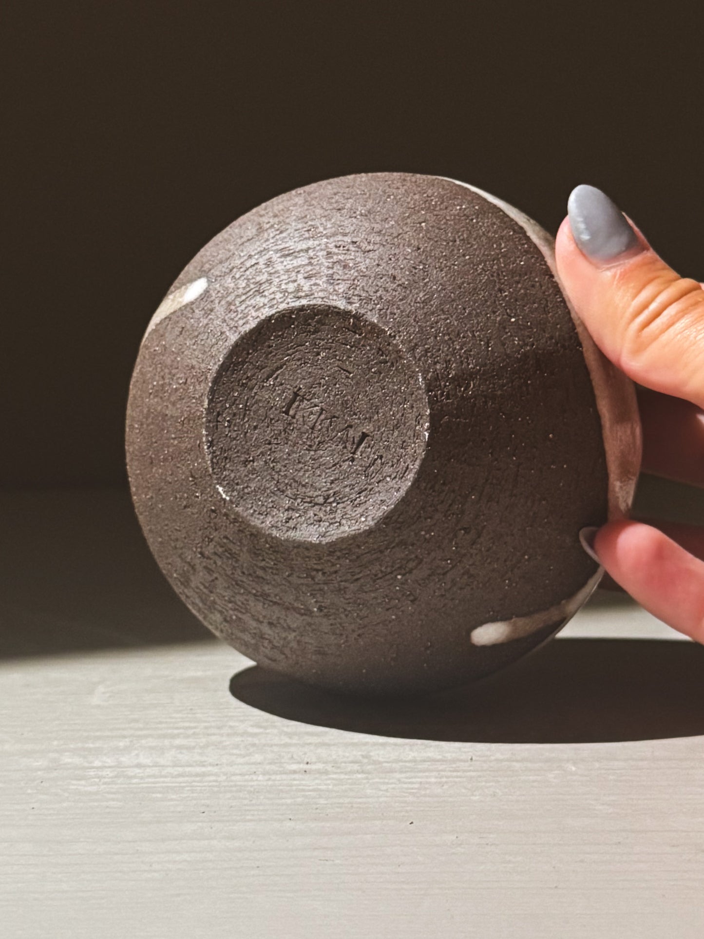 Orb Vase – Yuki Black #11 showcasing its unique rounded form and organic glaze patterns.