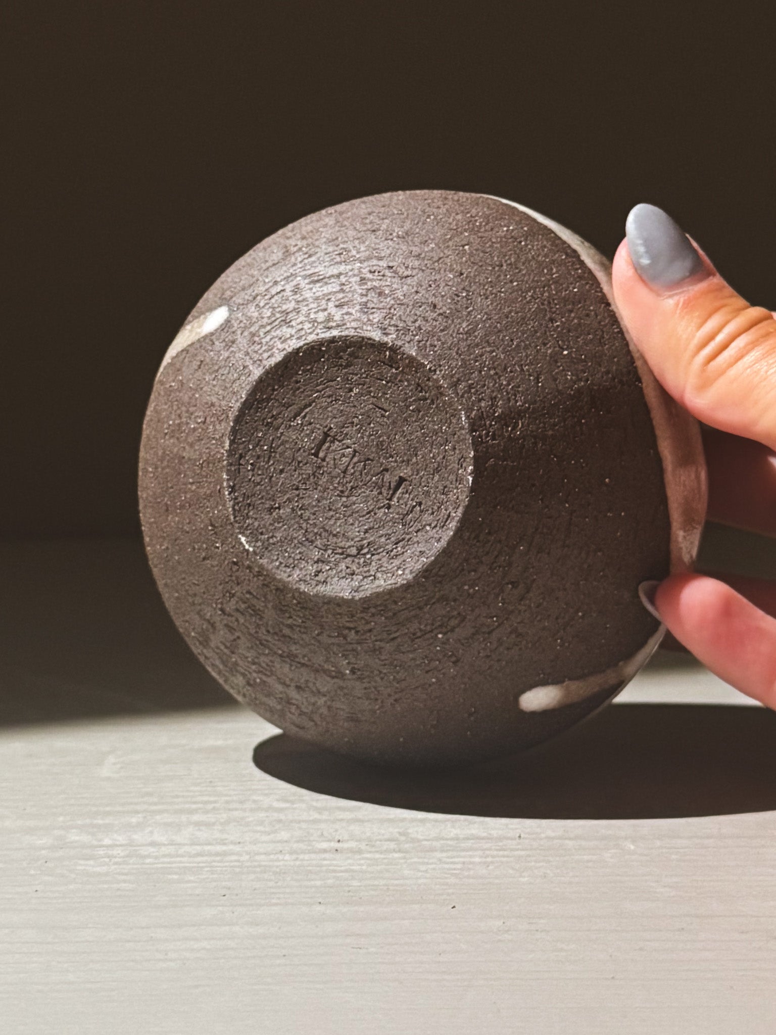 Orb Vase – Yuki Black #11 showcasing its unique rounded form and organic glaze patterns.