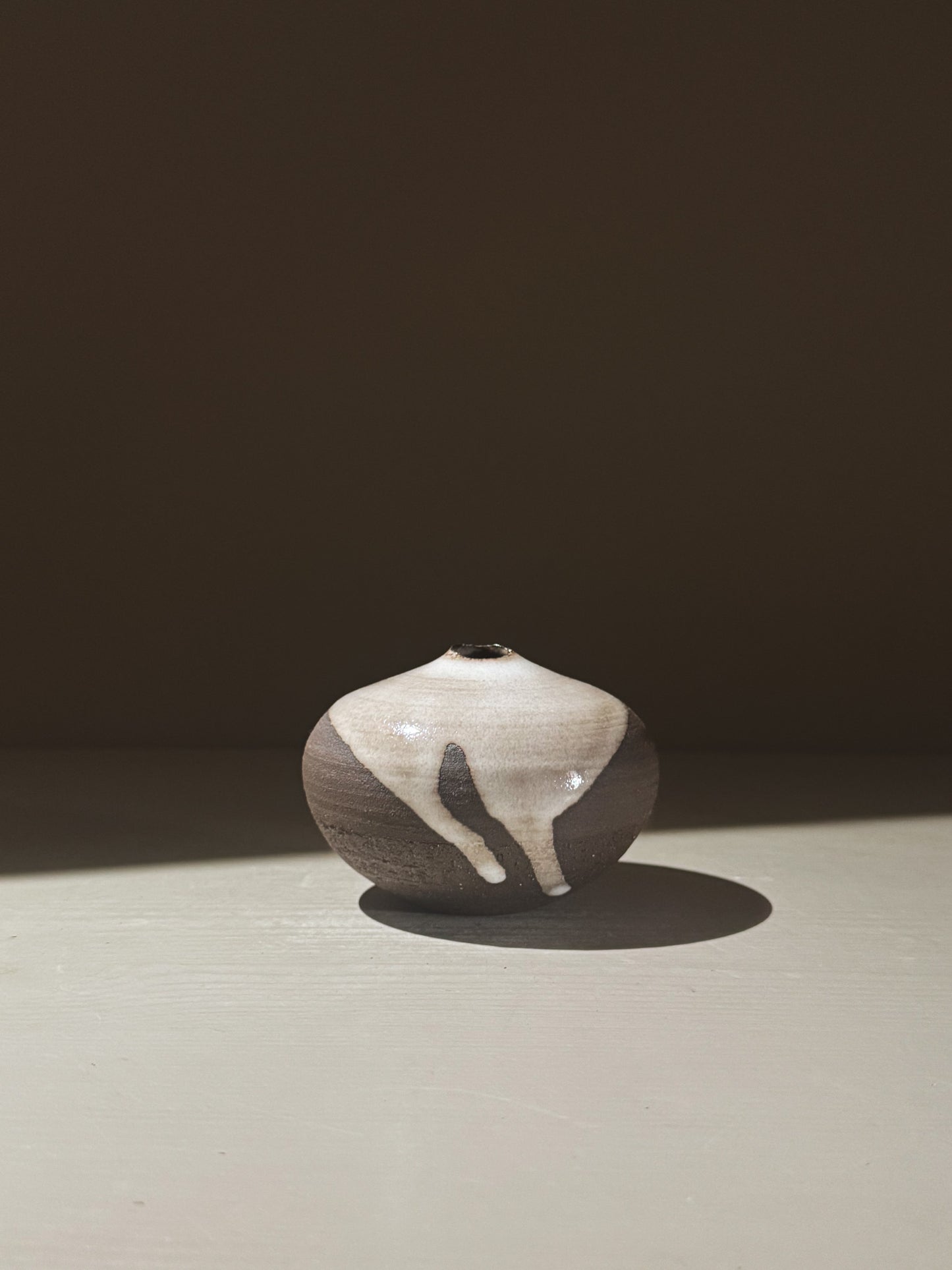 Orb Vase – Yuki Black #12 showcasing a unique glaze with organic patterns and a soft spherical form.