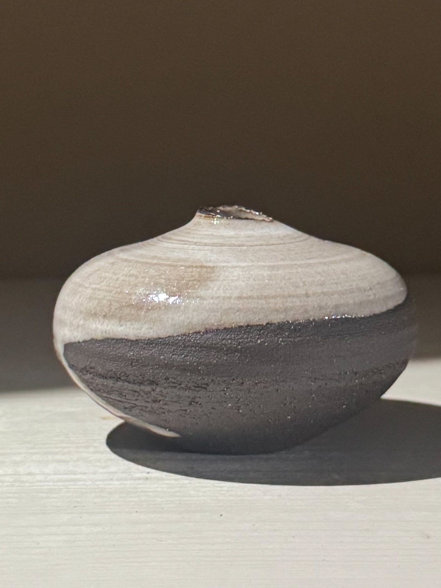 Orb Vase – Yuki Black #13, a unique rounded ceramic vase with natural glaze patterns.