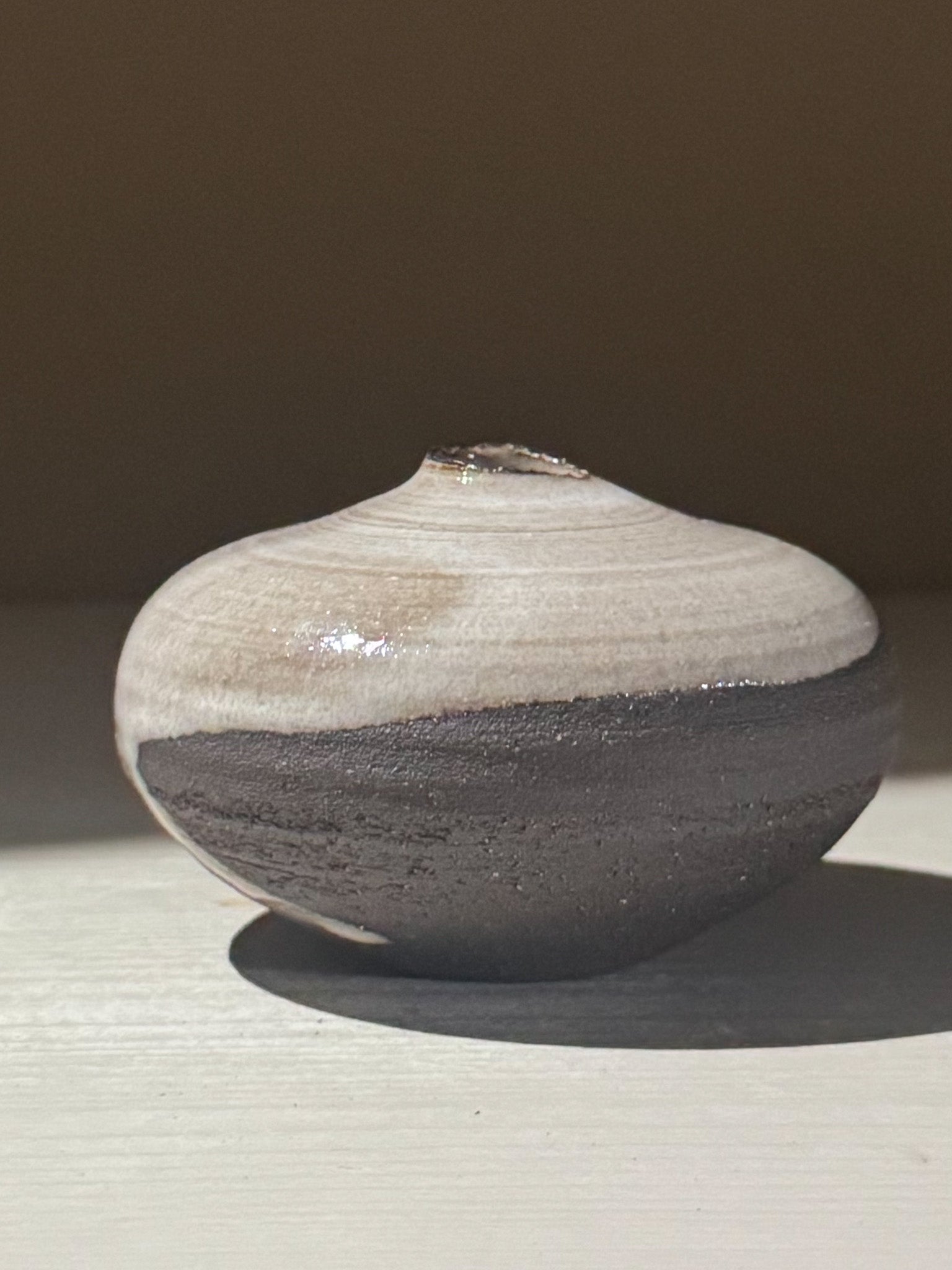 Orb Vase – Yuki Black #13, a unique rounded ceramic vase with natural glaze patterns.