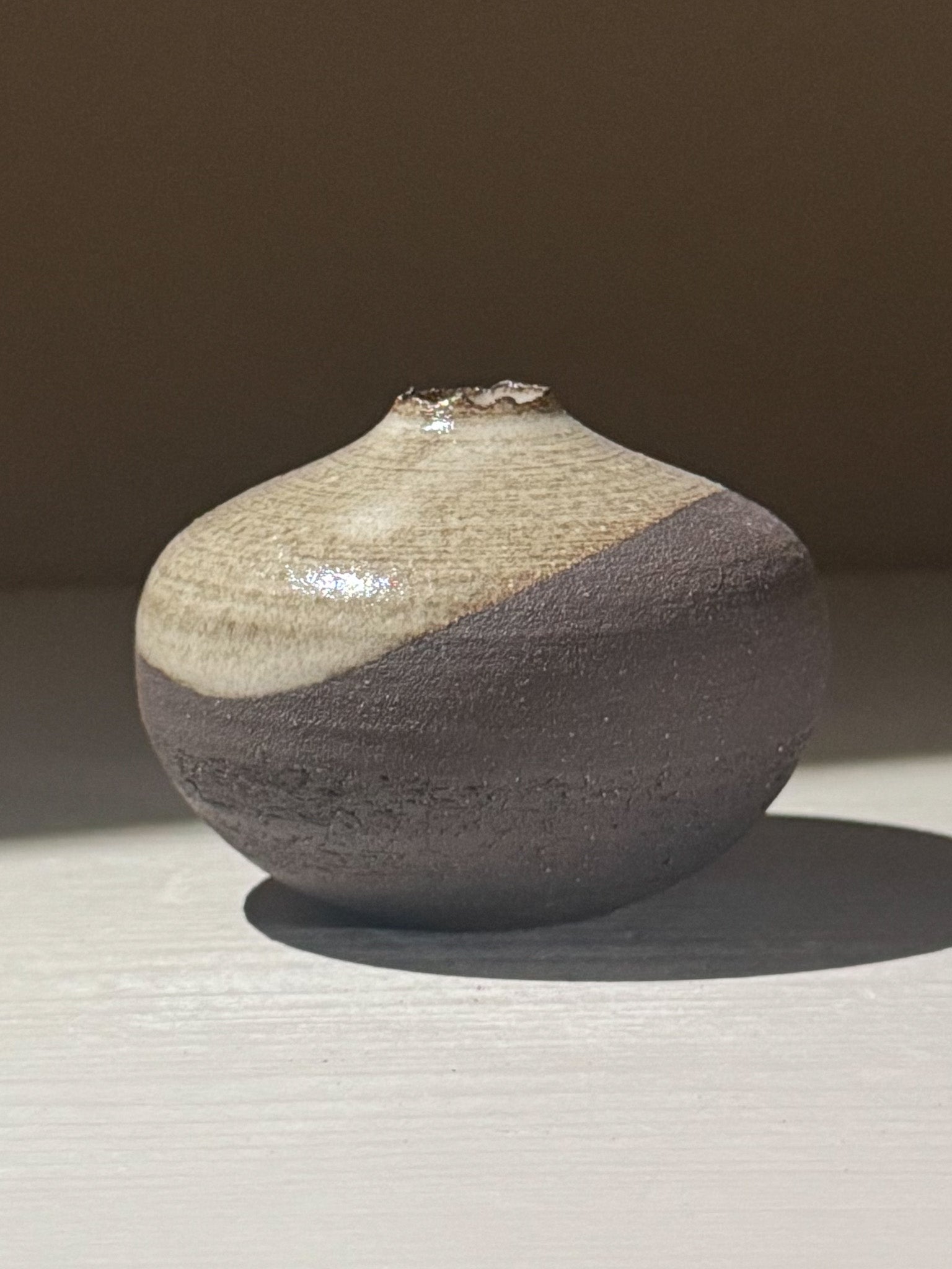 Orb Vase – Yuki Black #14, a unique rounded ceramic vase with organic glaze patterns and soft spherical form.