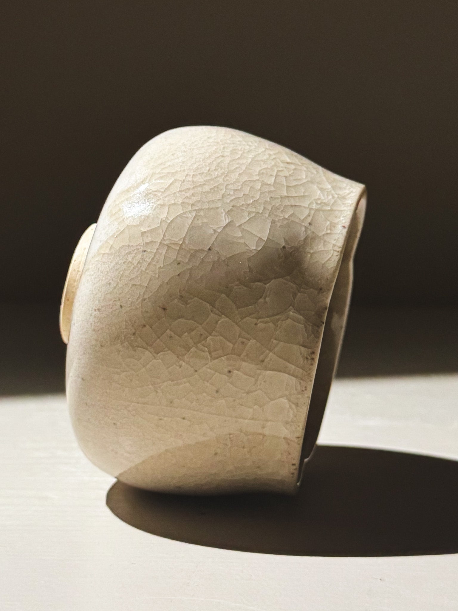 Yunomi Cup - Kannyū Series  #10 displayed in elegant side view, showcasing its crackle glaze and softly flowing rim.