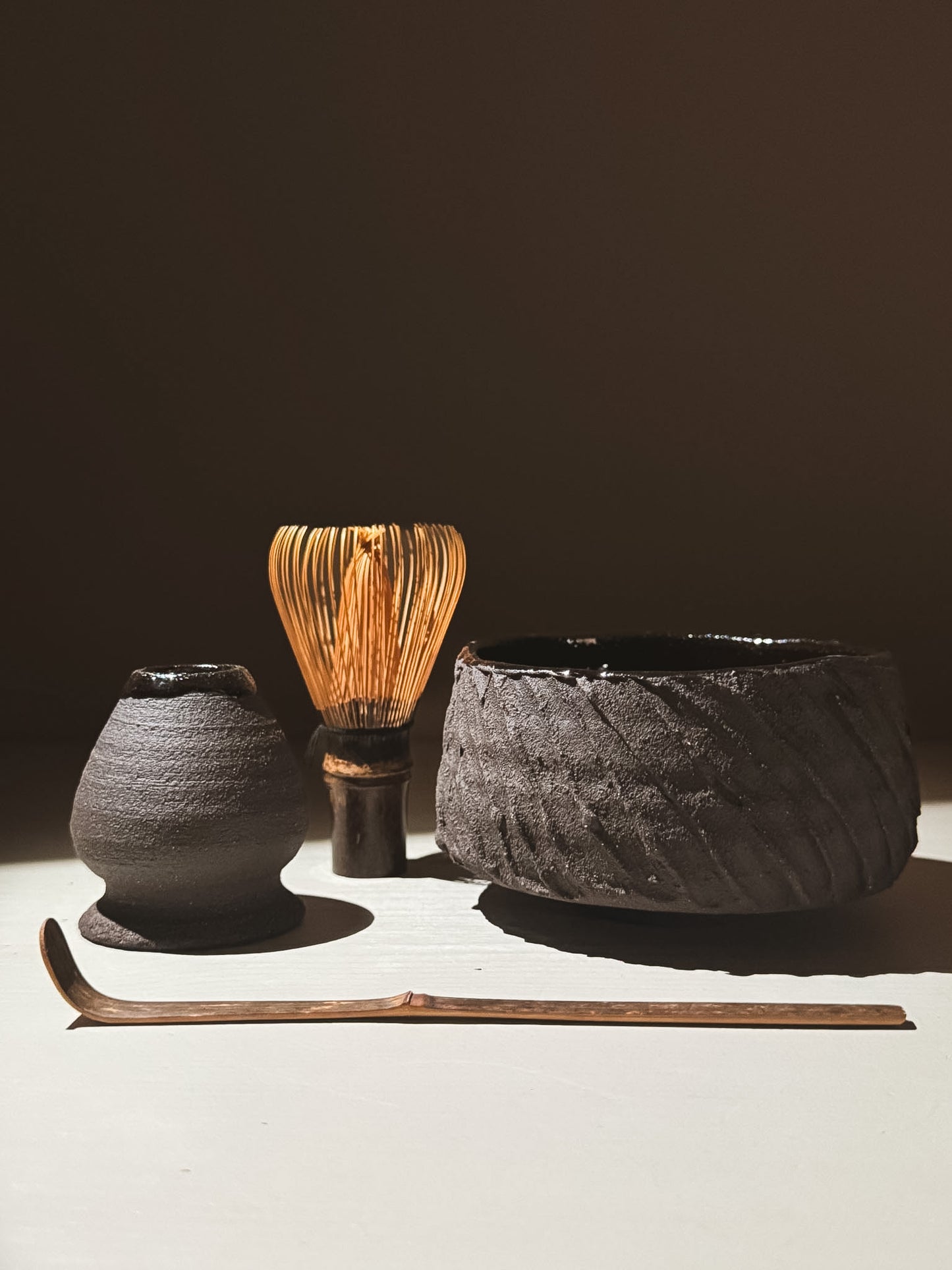 Kuro Matcha Bowl #03 with traditional whisk, scoop, and chawan in textured dark tones and glossy finish.