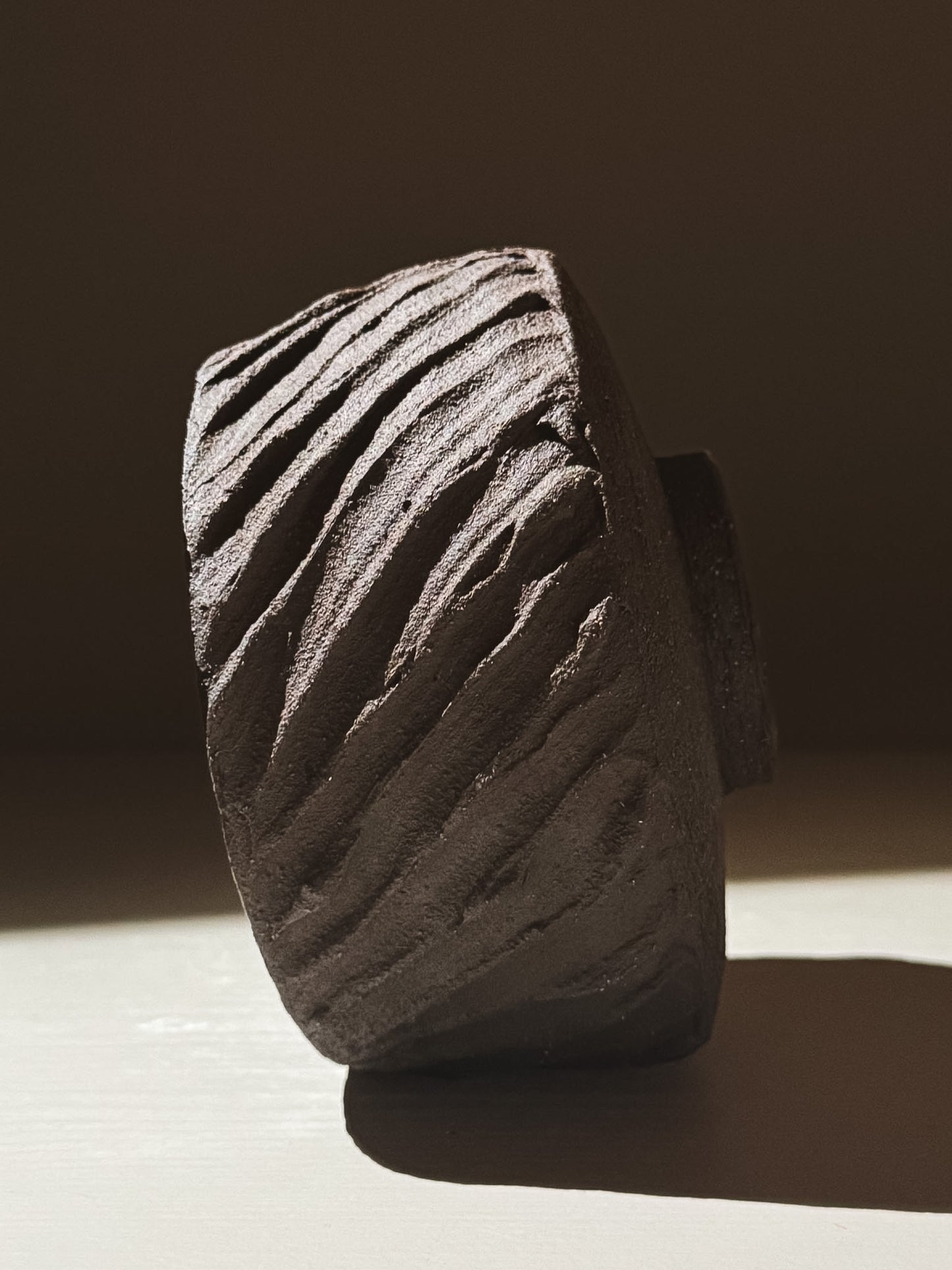 Kuro Matcha Bowl #01 showcasing dark textured exterior and earthy volcanic stone inspiration.