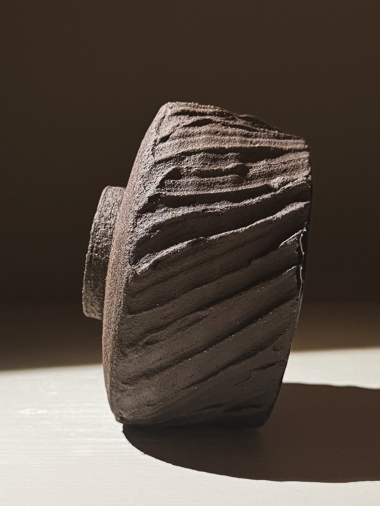 Kuro Matcha Bowl #01 showcasing earthy textures and dark natural tones with a textured brown exterior.