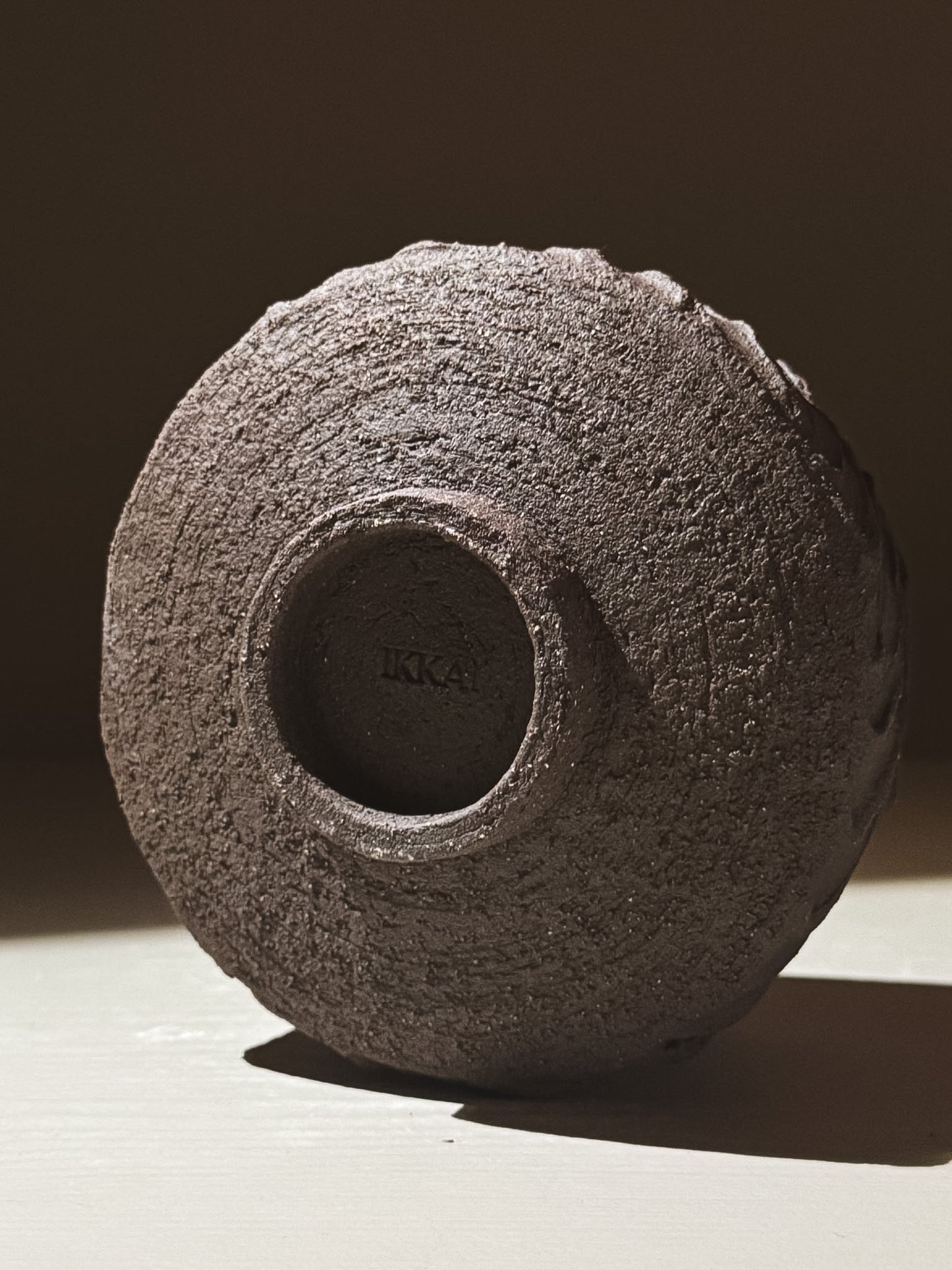 Kuro Matcha Bowl #01 featuring a textured dark brown slip exterior and smooth glossy glaze interior.