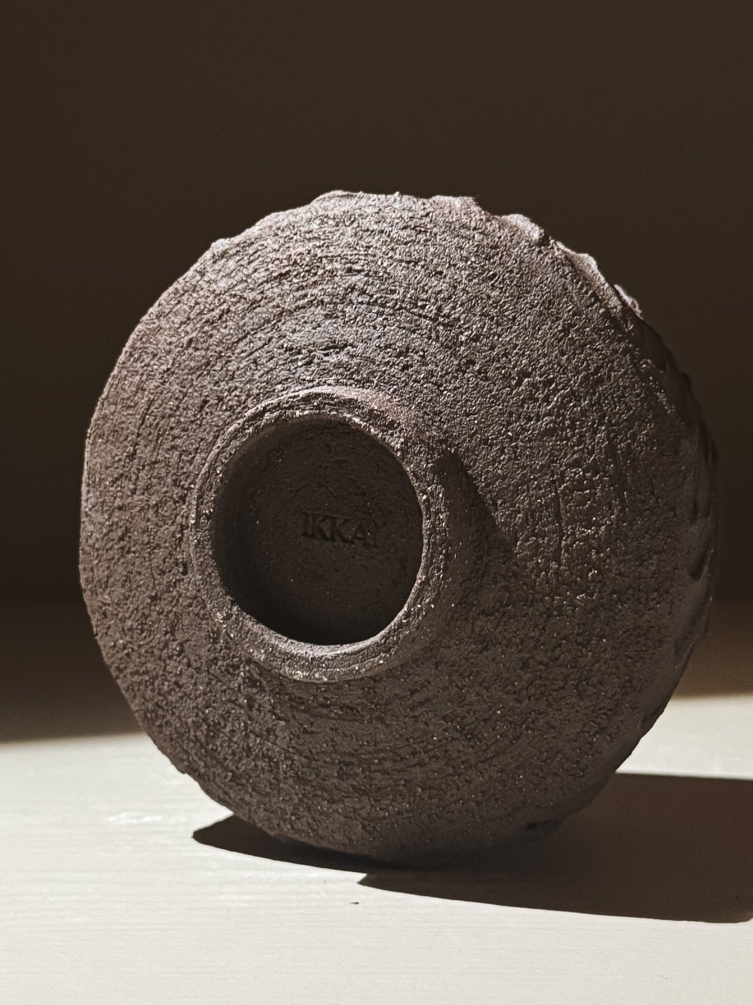 Kuro Matcha Bowl #01 featuring a textured dark brown slip exterior and smooth glossy glaze interior.