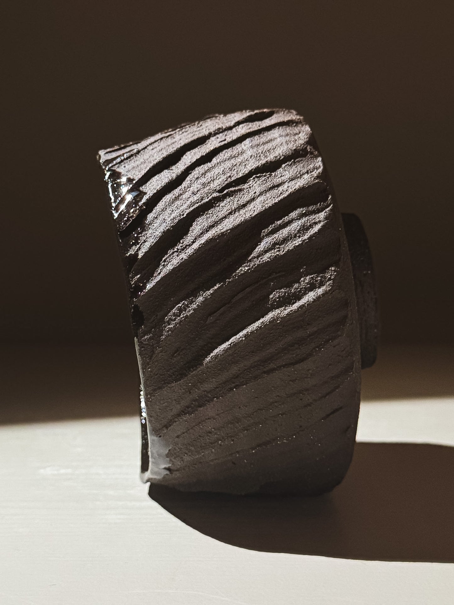 Kuro Matcha Bowl #02 showcasing volcanic stone-inspired texture and deep glossy finish.