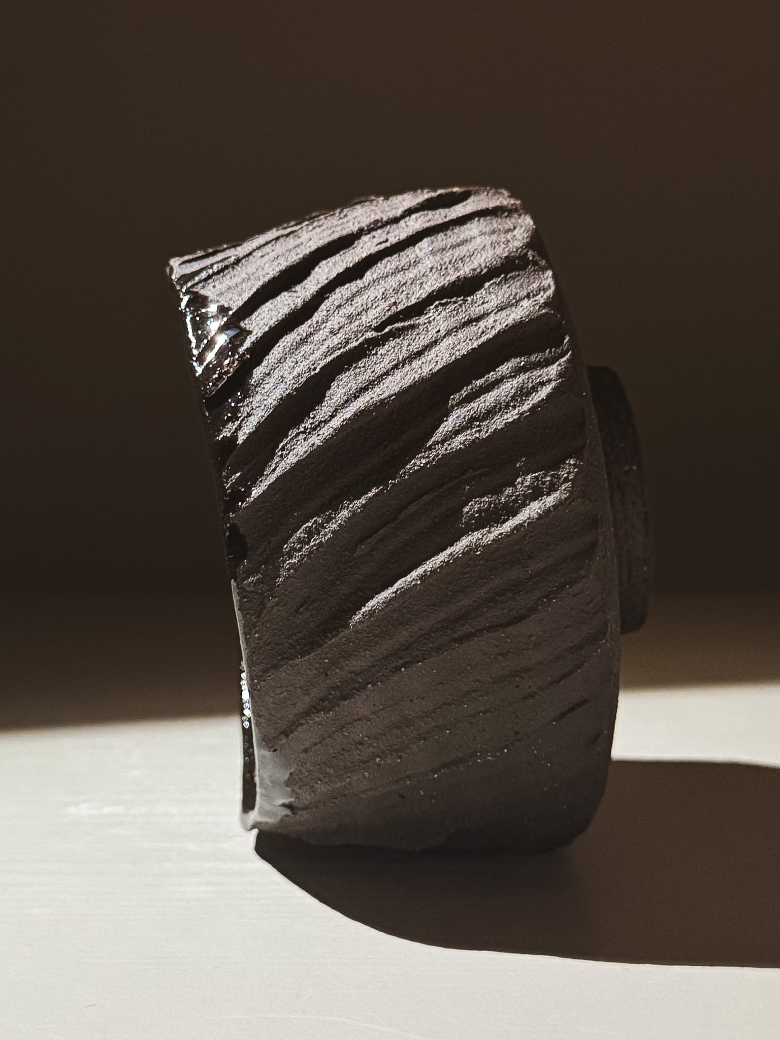 Kuro Matcha Bowl #02 showcasing volcanic stone-inspired texture and deep glossy finish.