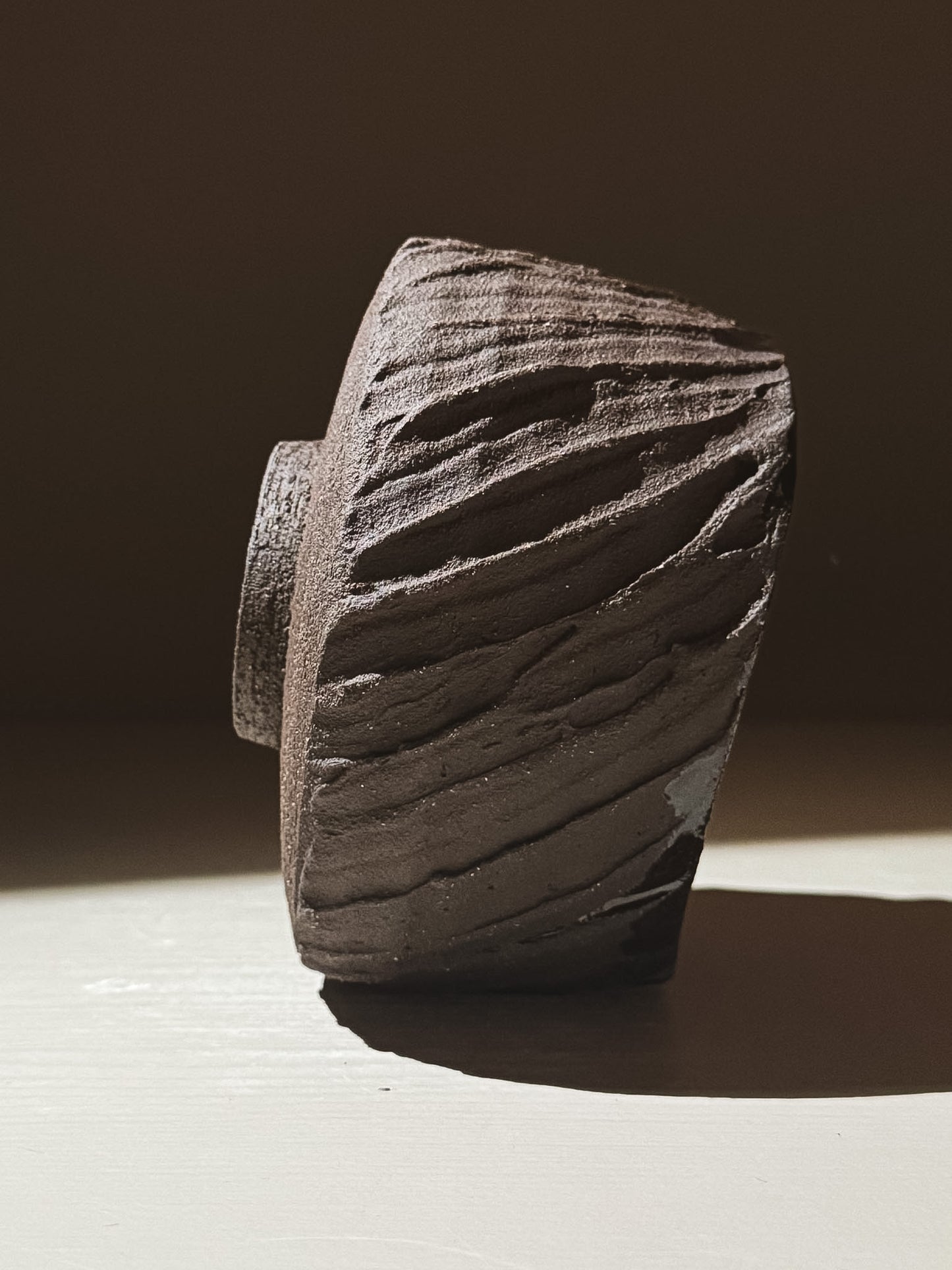 Kuro Matcha Bowl #02 featuring textured dark brown slip and glossy interior, inspired by volcanic stone.