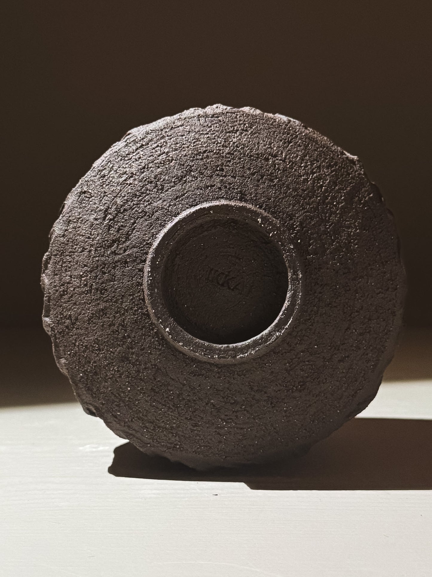 Bottom view of Kuro Matcha Bowl #02, showcasing its textured dark brown slip finish.