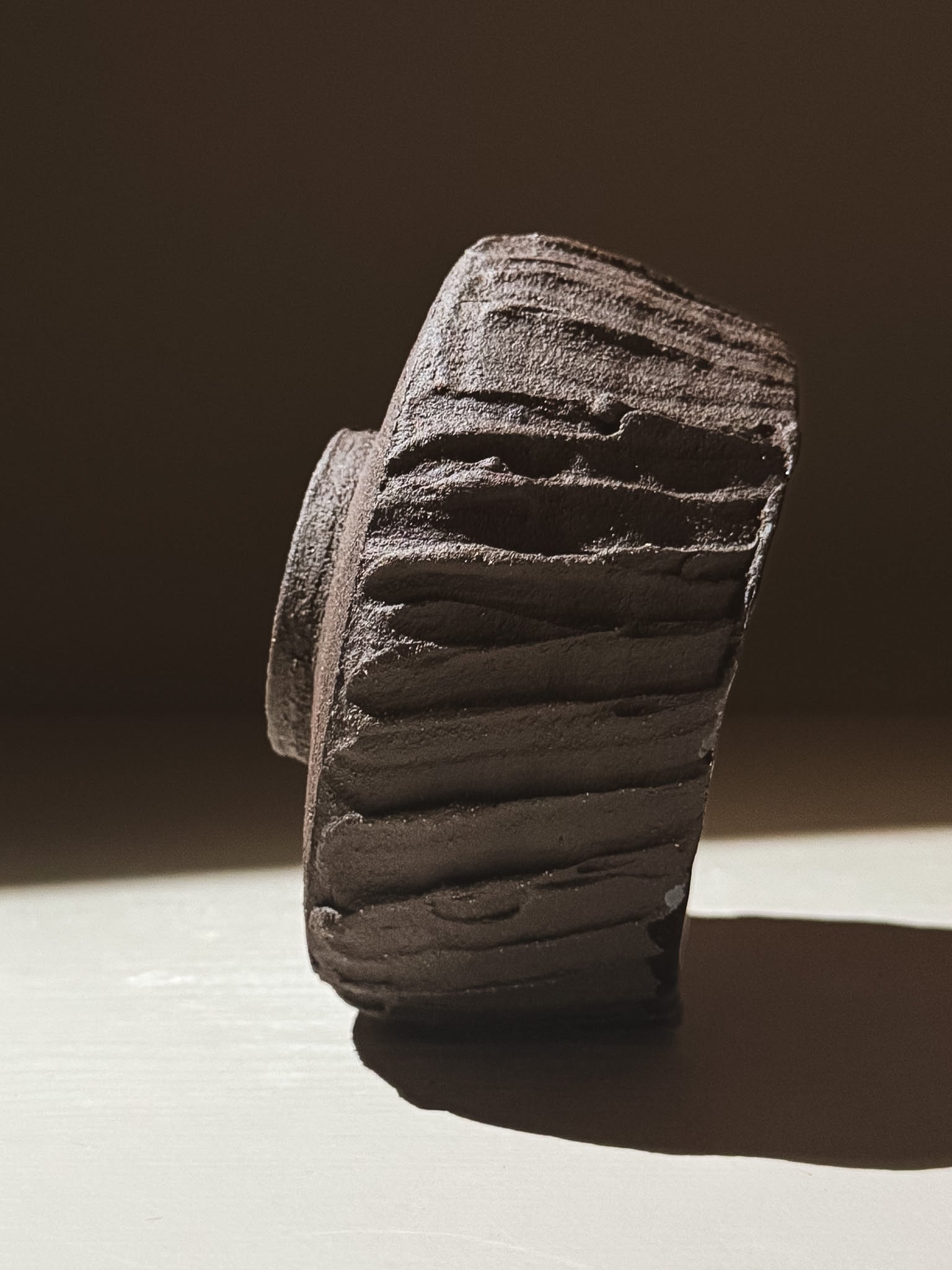 Kuro Matcha Bowl #03 side view showing textured dark brown exterior and earthy natural tones.