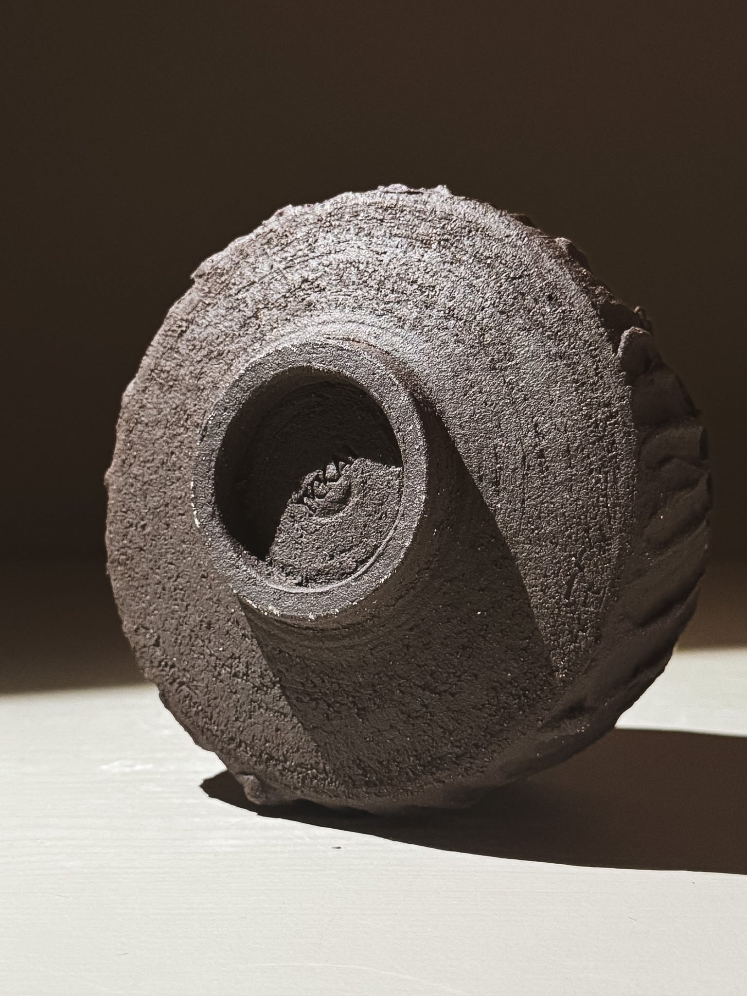 Kuro Matcha Bowl #03 showcasing its textured dark brown exterior and unique volcanic stone-inspired design.