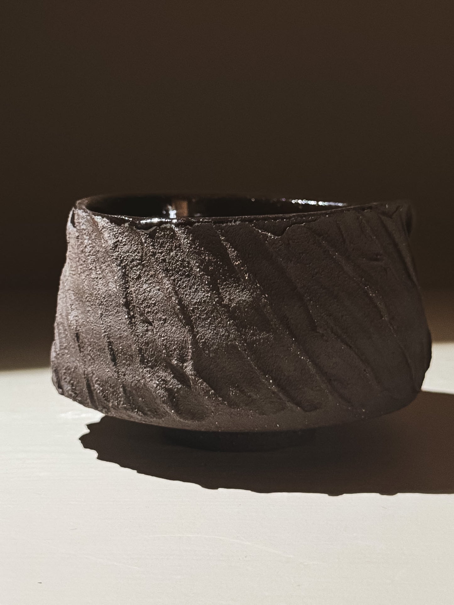 Kuro Matcha Bowl #04 featuring textured dark brown slip and glossy dark glaze for a stunning contrast.