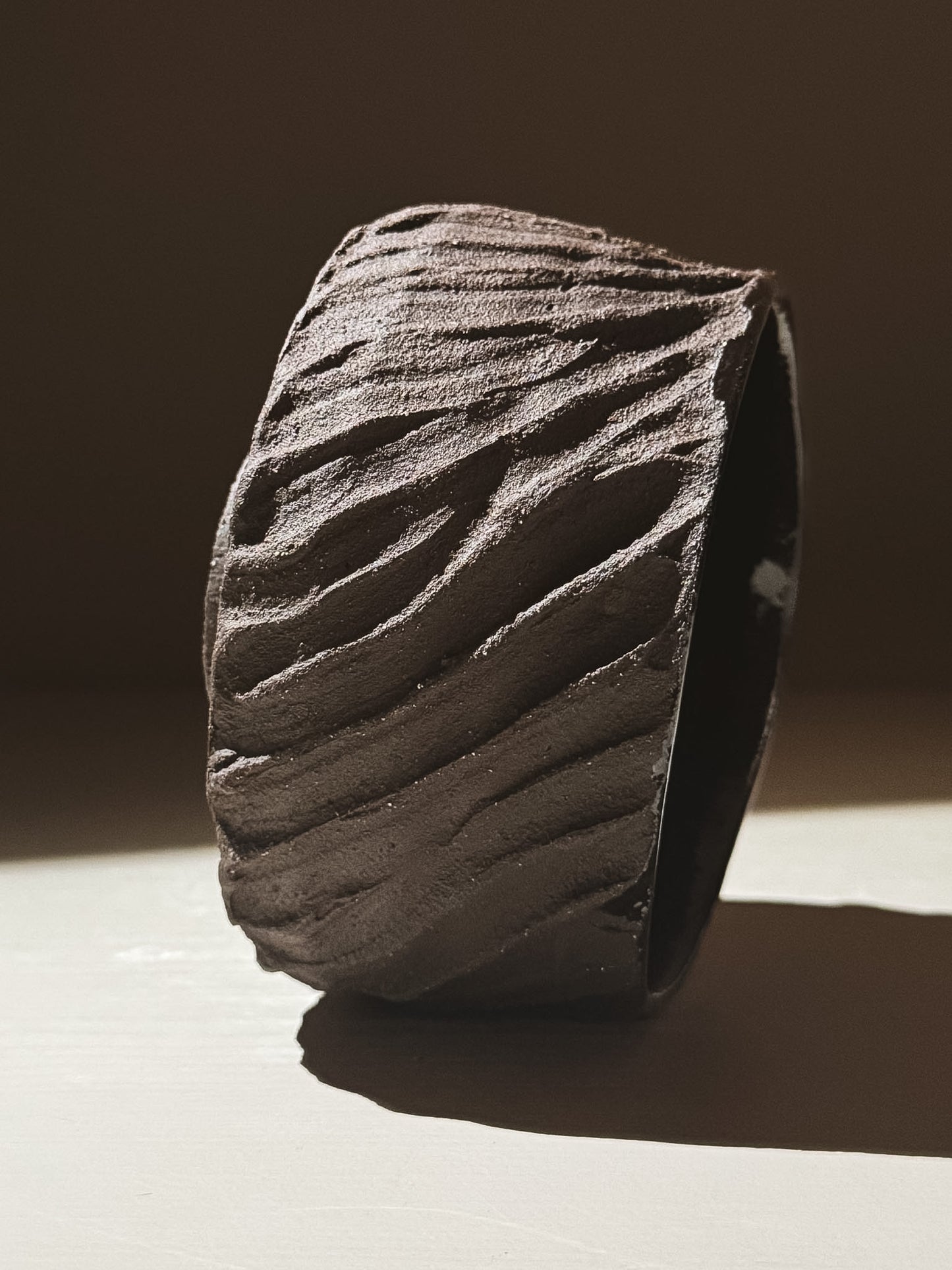 Kuro Matcha Bowl #04 featuring a textured dark brown slip exterior inspired by volcanic stone.