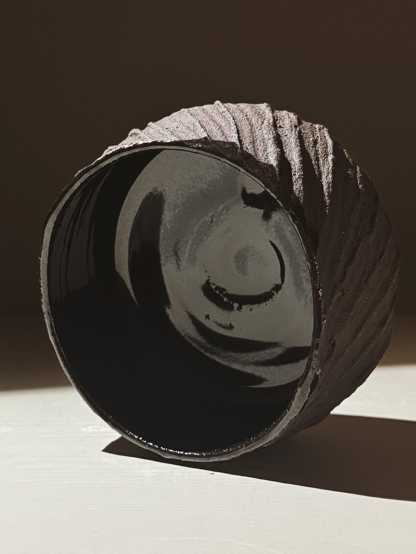 Kuro Matcha Bowl #05 showcasing a textured dark brown exterior and glossy interior under natural light.