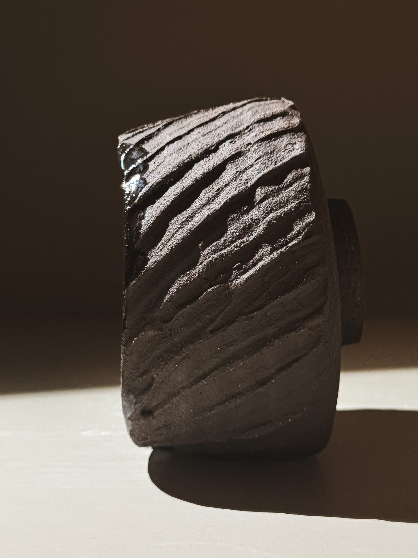 Kuro Matcha Bowl #05 side view showcasing volcanic-inspired textures and glossy interior finish.