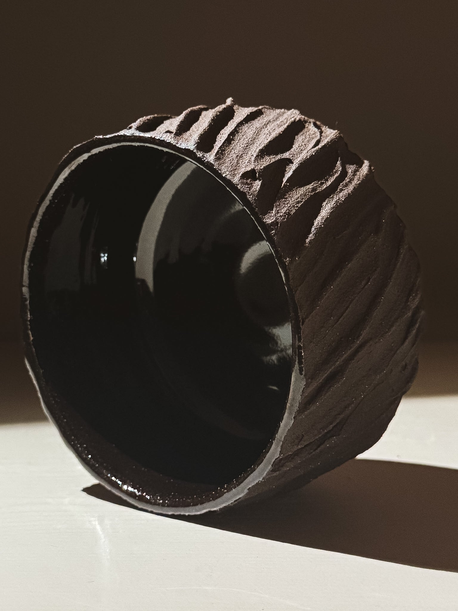 Kuro Matcha Bowl #06 with textured dark brown exterior and glossy black interior, showcasing earthy volcanic stone inspiration.