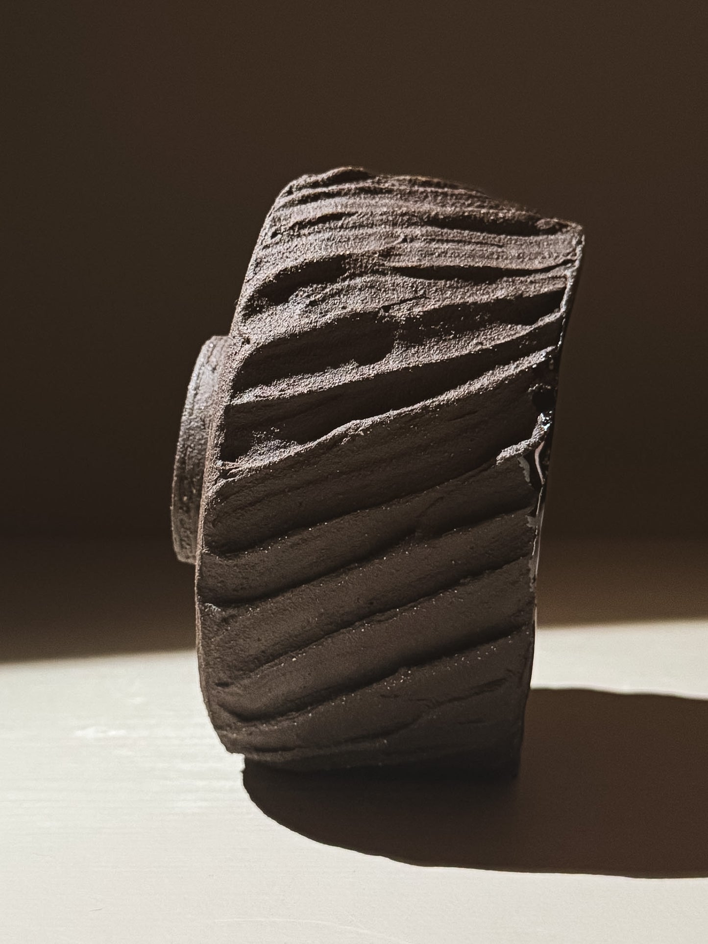 Kuro Matcha Bowl #06 with a heavily textured dark brown slip exterior, showcasing earthy volcanic stone inspirations.