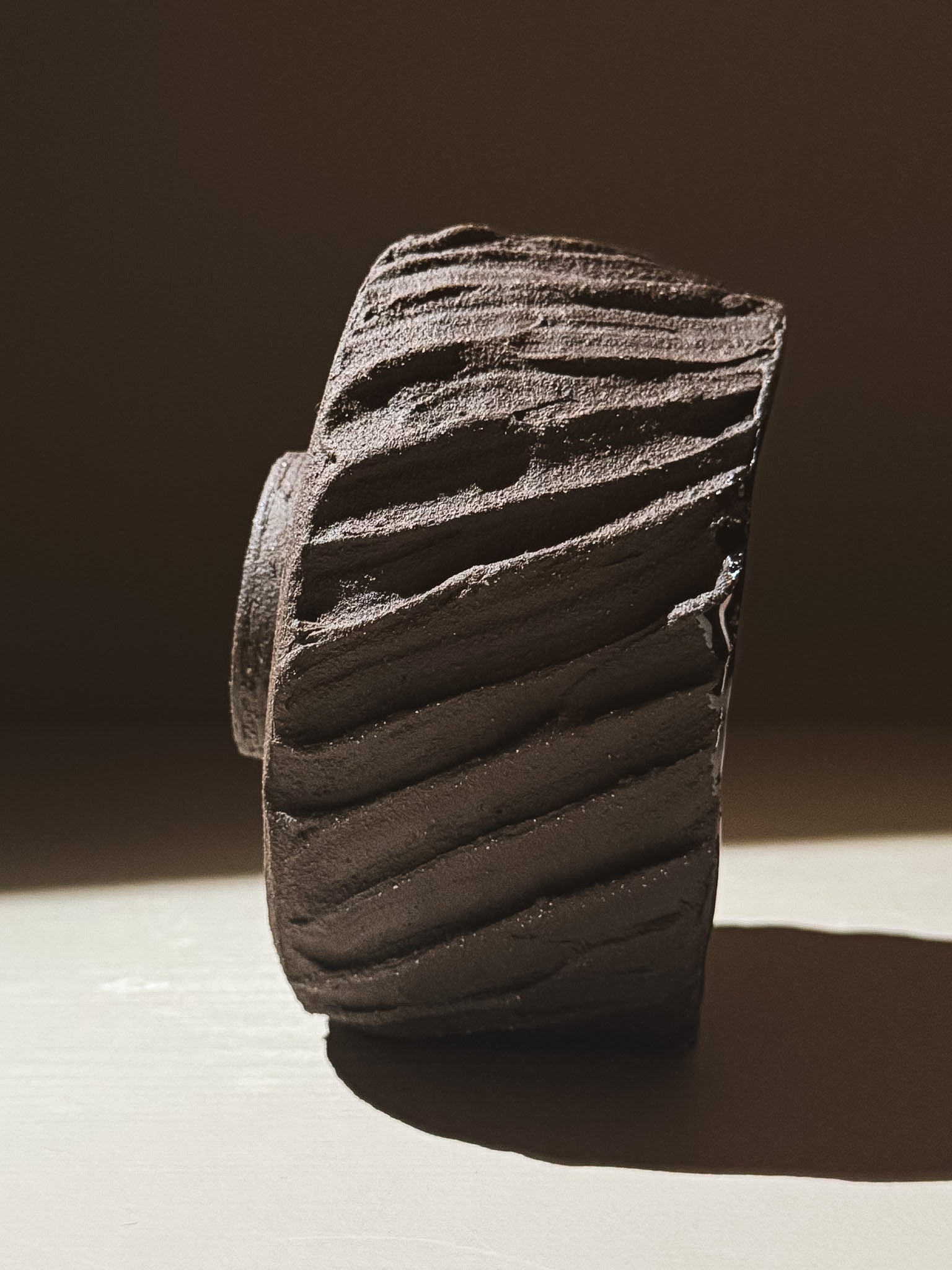 Kuro Matcha Bowl #06 with a heavily textured dark brown slip exterior, showcasing earthy volcanic stone inspirations.