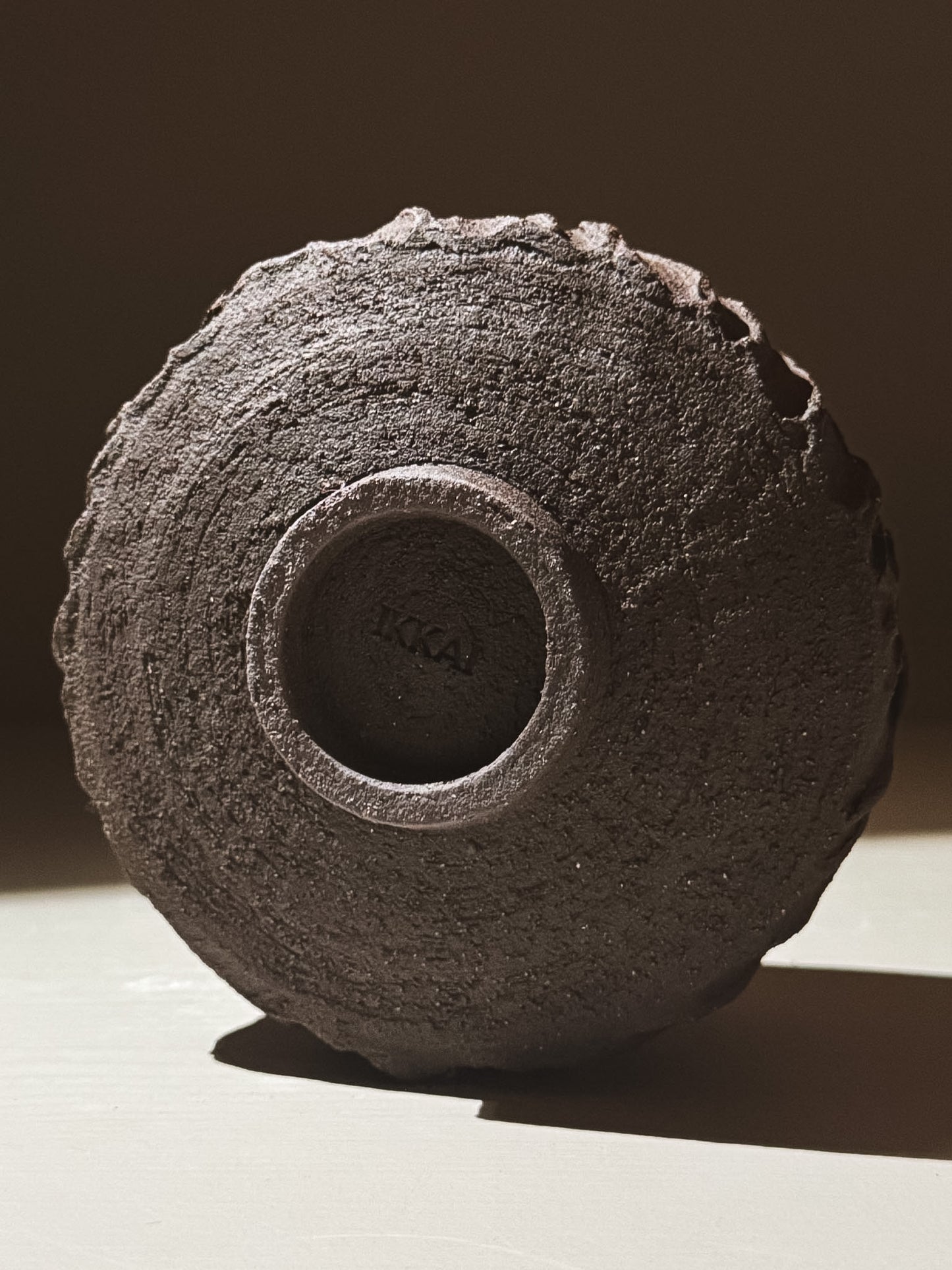 Bottom view of Kuro Matcha Bowl #06 showcasing textured dark brown finish.