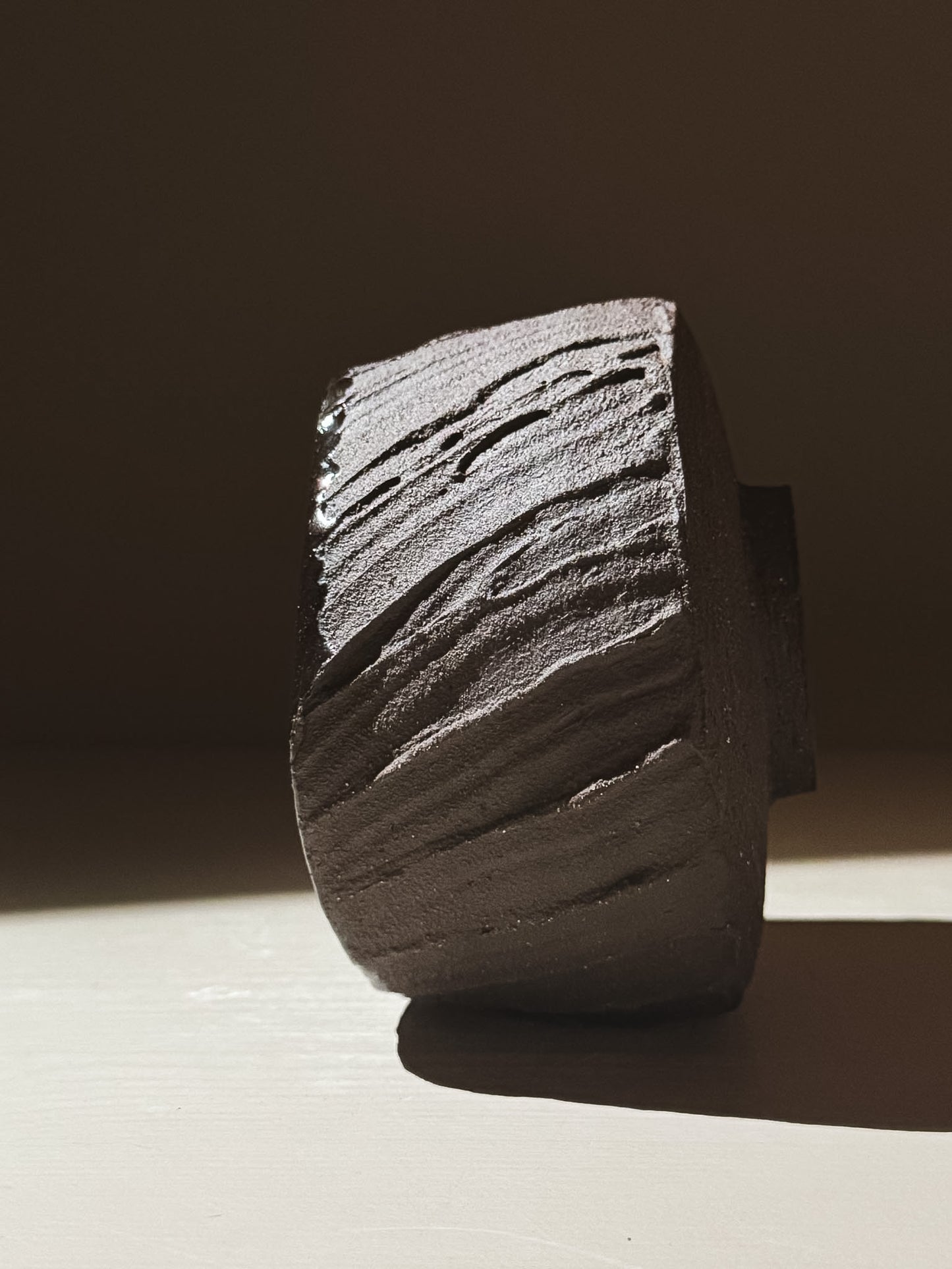 Kuro Matcha Bowl #07 showcasing textured dark brown slip exterior and a glossy dark glaze interior in beautiful light.