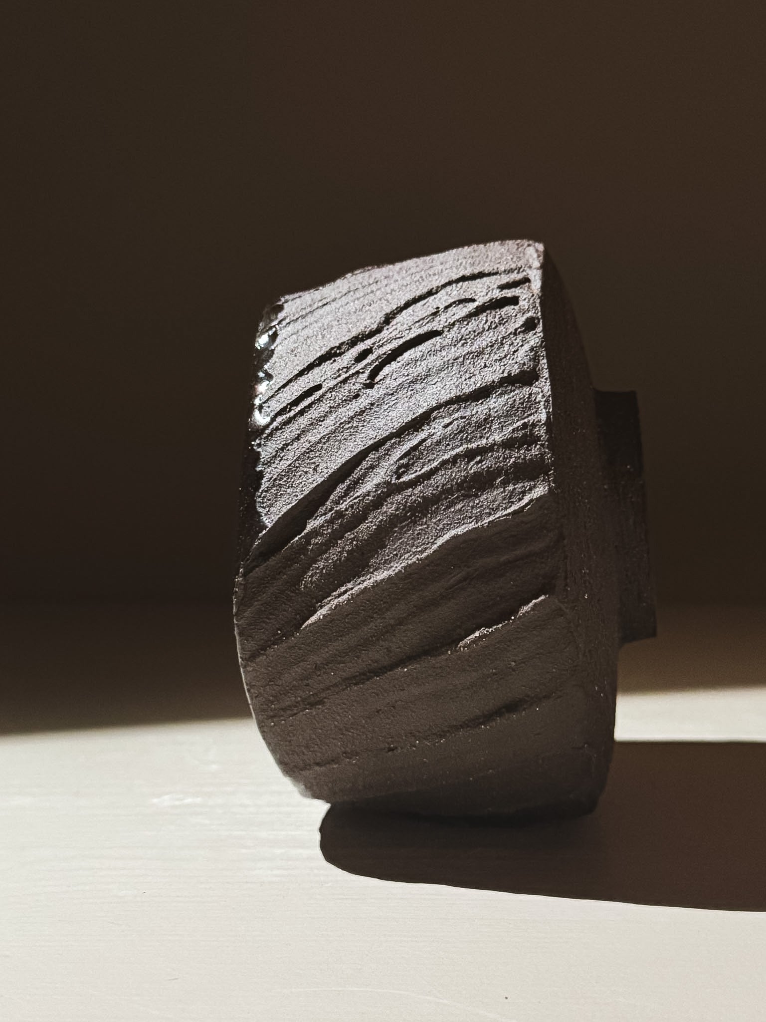 Kuro Matcha Bowl #07 showcasing textured dark brown slip exterior and a glossy dark glaze interior in beautiful light.