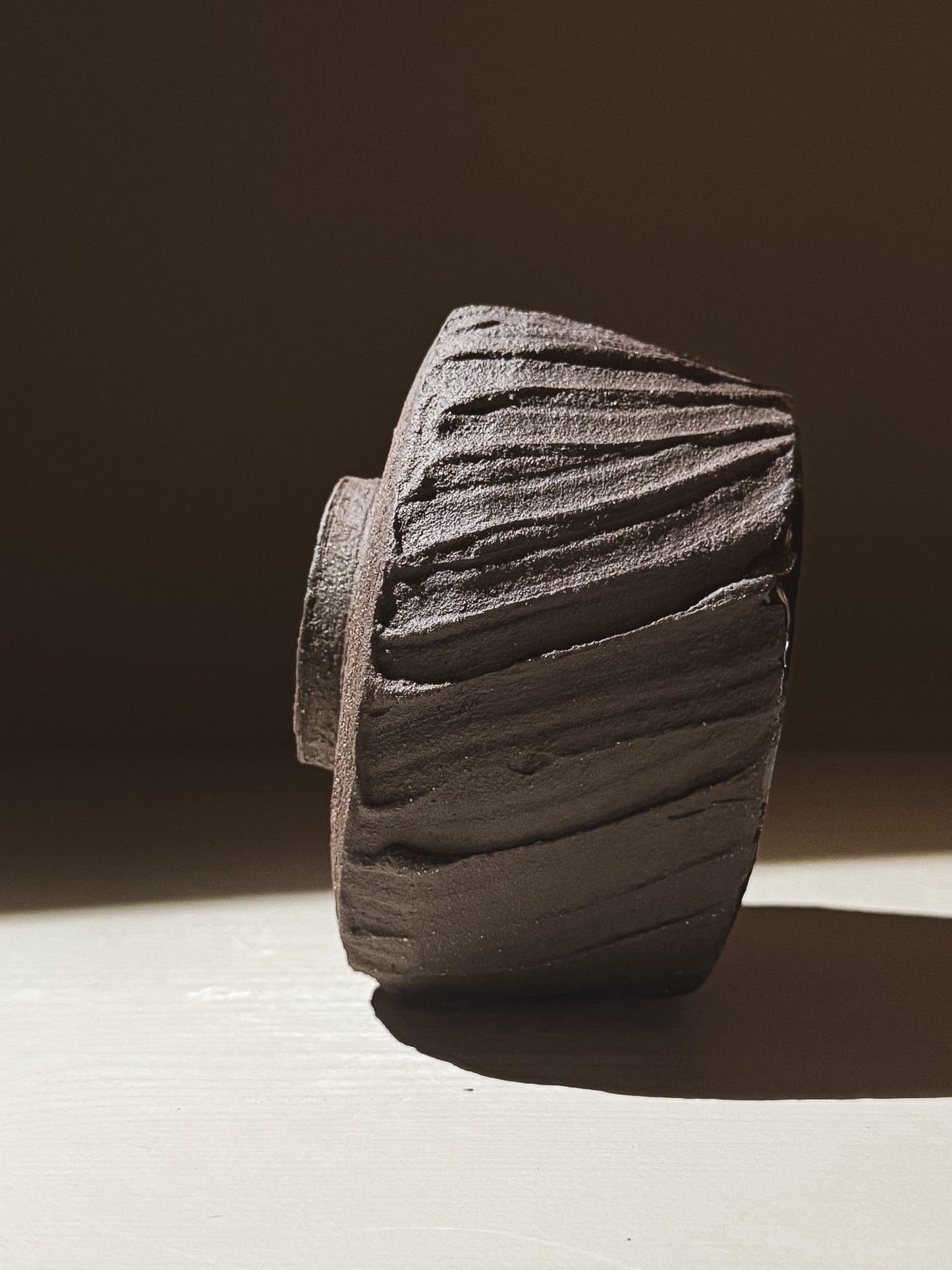 Kuro Matcha Bowl #07 showcasing earthy textures and dark tones with a rough exterior and smooth glossy interior.