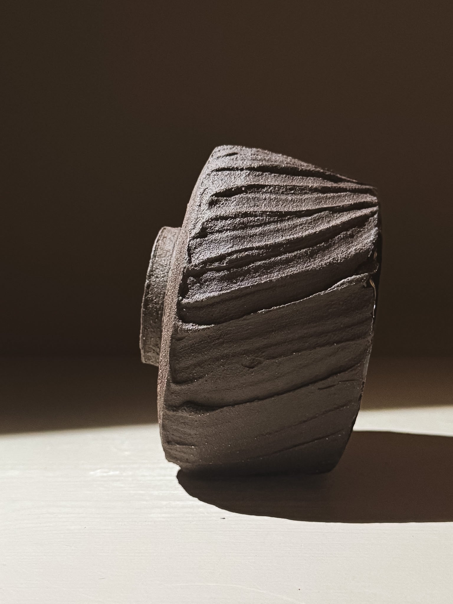 Kuro Matcha Bowl #07 showcasing earthy textures and dark tones with a rough exterior and smooth glossy interior.