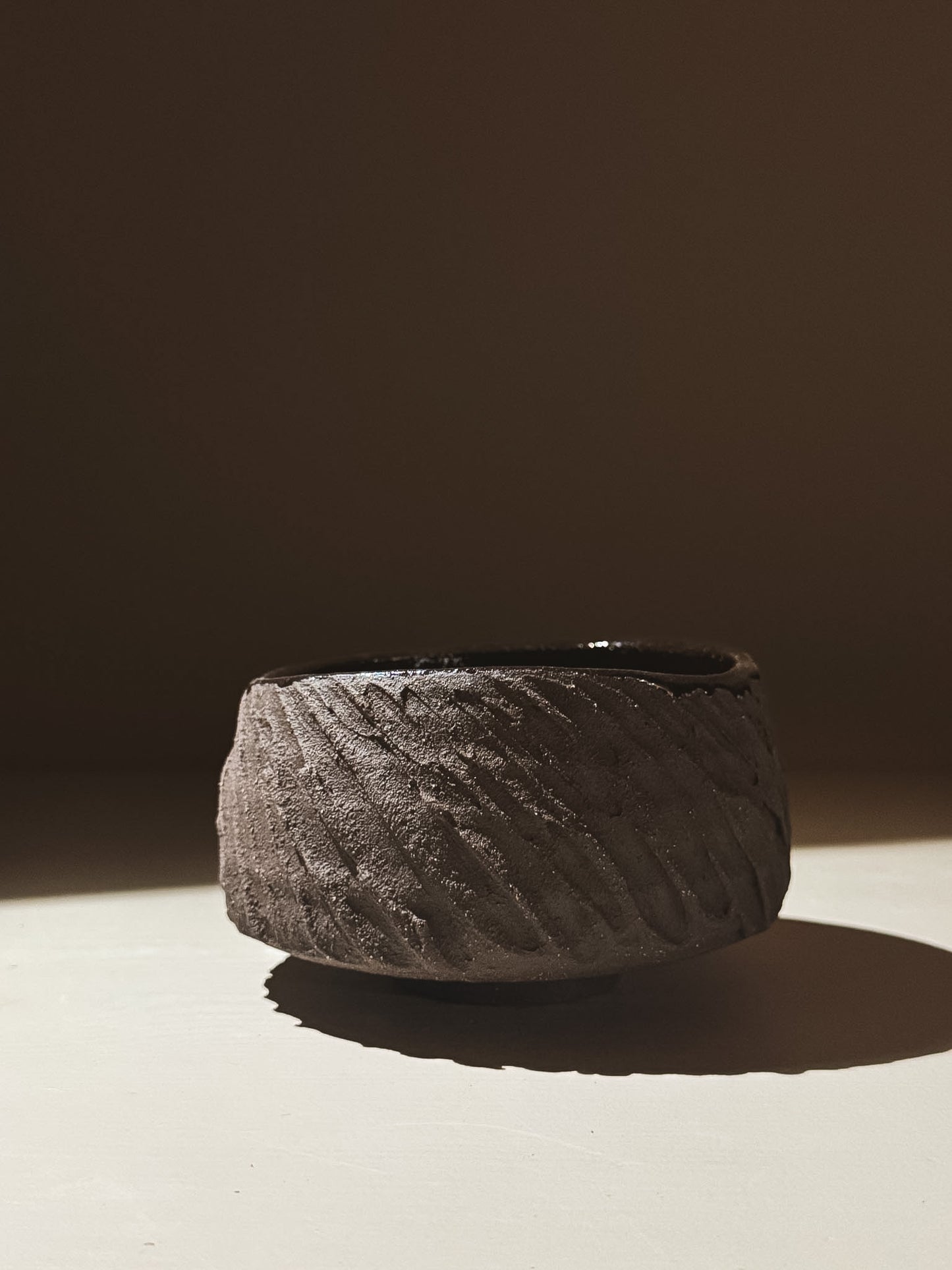 Kuro Matcha Bowl #08 with textured dark brown finish and glossy interior, inspired by volcanic stone.