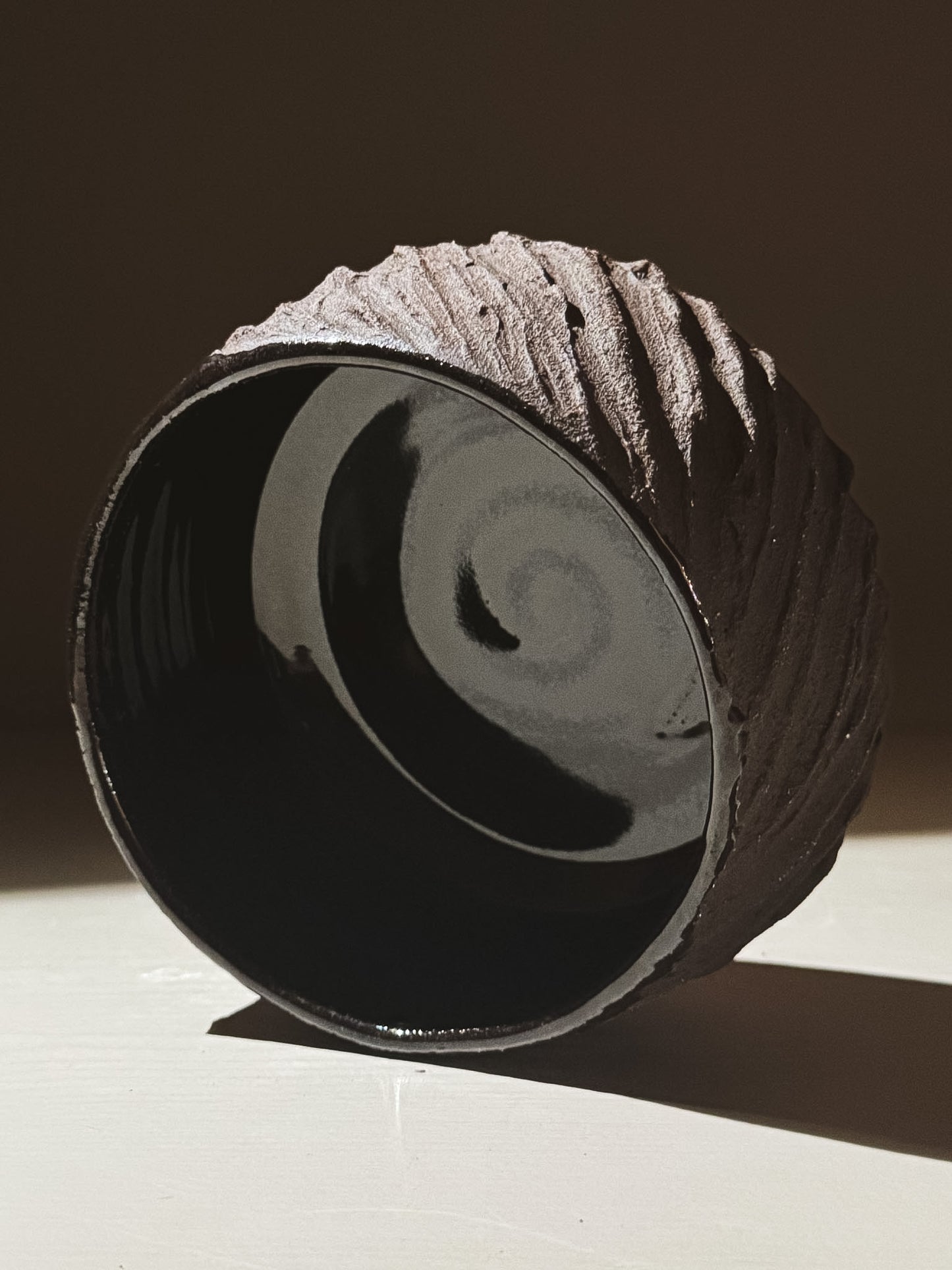 Kuro Matcha Bowl #08 showcasing volcanic stone texture and glossy dark interior, perfect for tea ceremony.