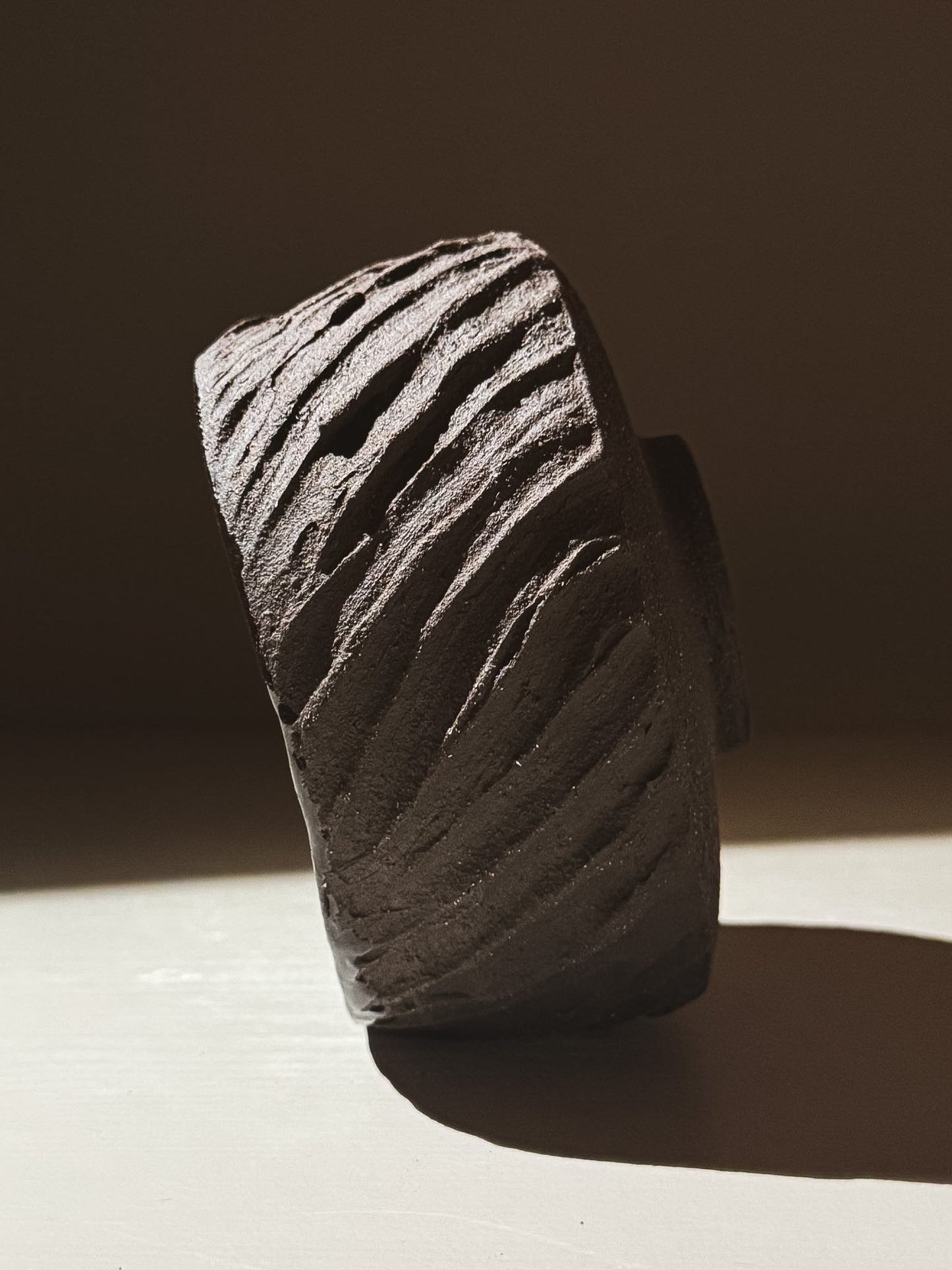 Kuro Matcha Bowl #08 showcasing textured dark brown slip and glossy interior, inspired by volcanic stone.