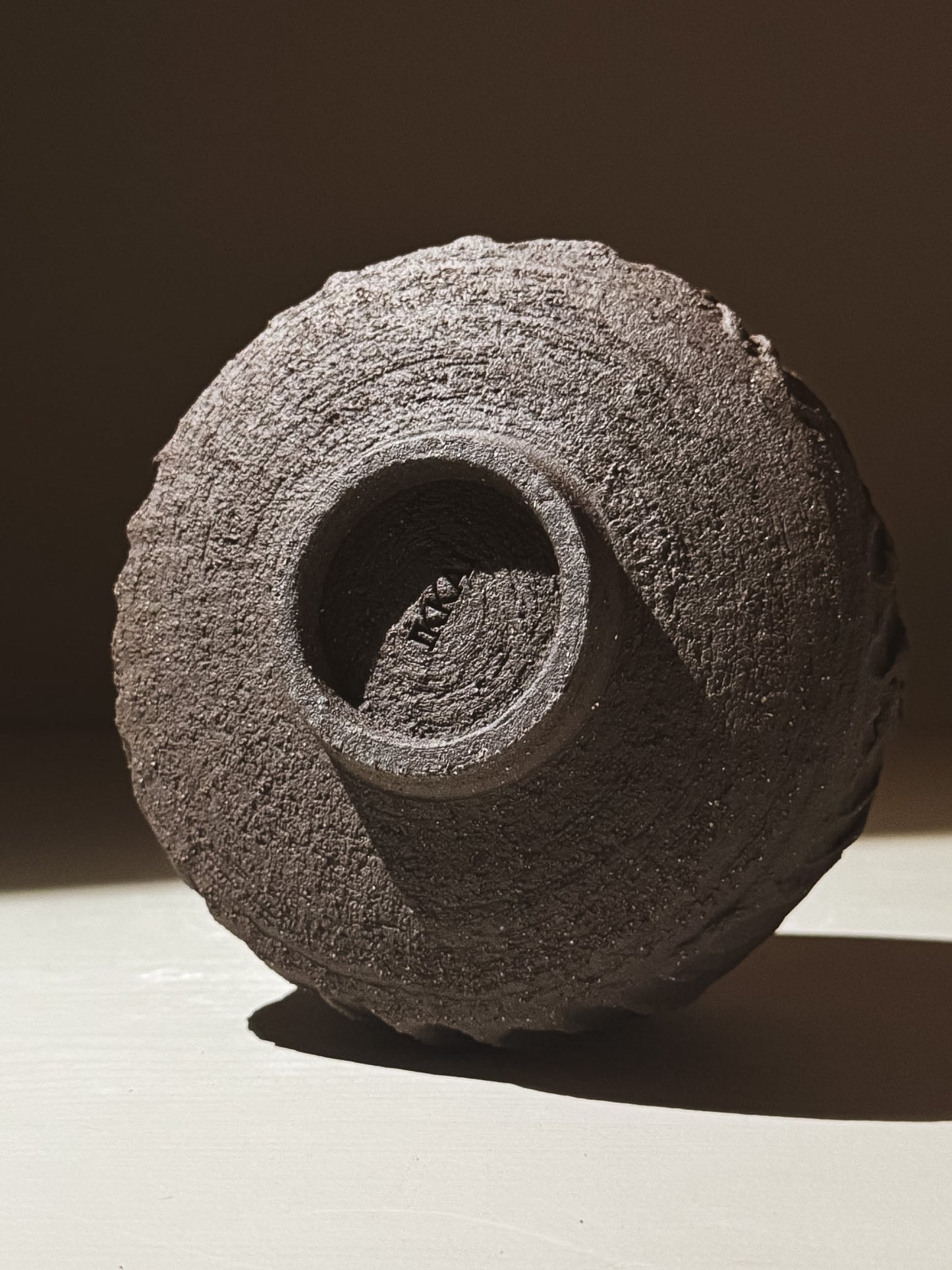 Kuro Matcha Bowl #08 with textured dark brown slip and unique earthy design, showcasing its volcanic stone inspiration.
