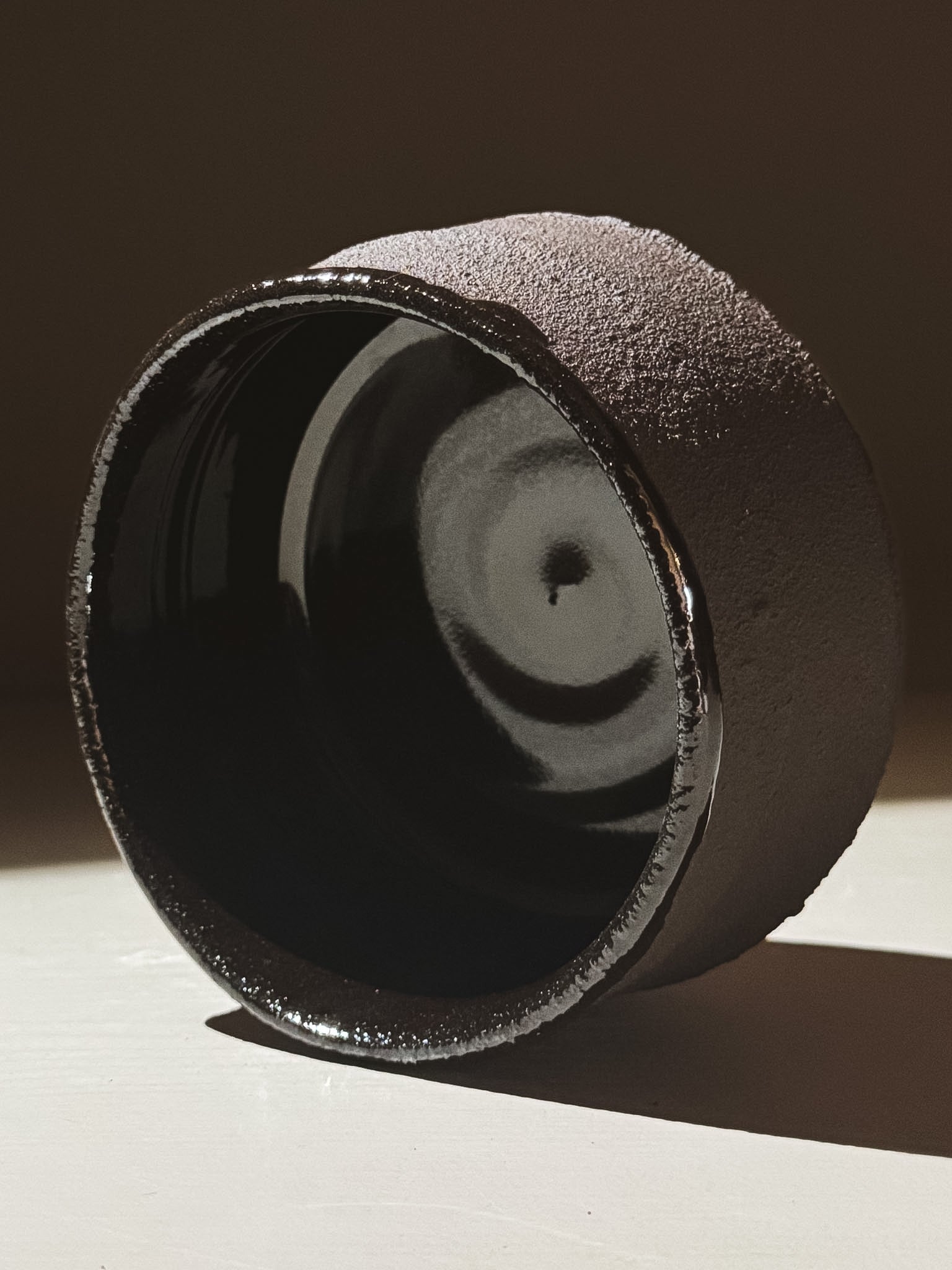 Kuro Matcha Bowl #09 showcasing a textured dark brown exterior and glossy black interior design.