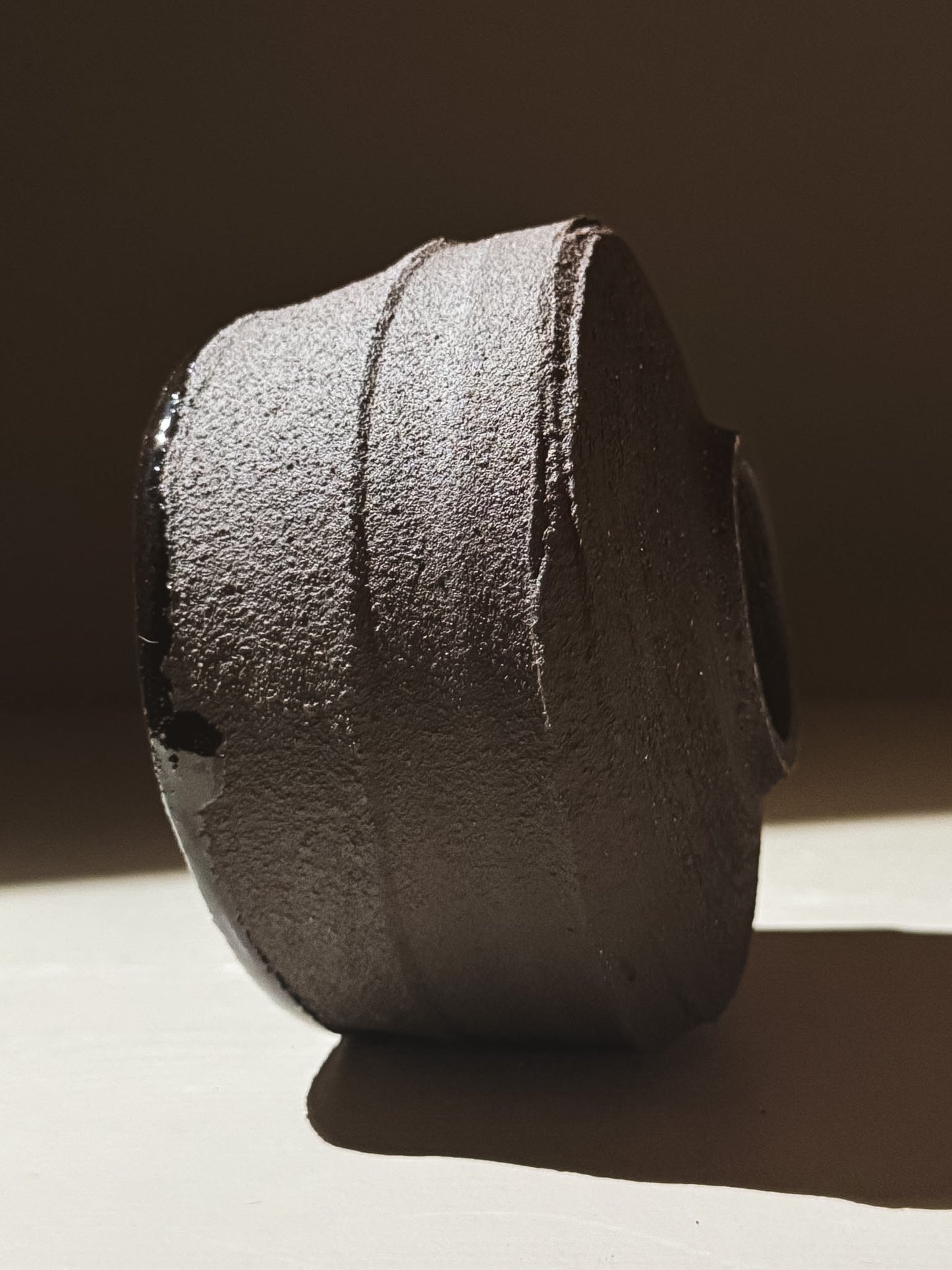 Kuro Matcha Bowl #09 showcasing textured dark brown slip and glossy interior surface for a striking contrast.