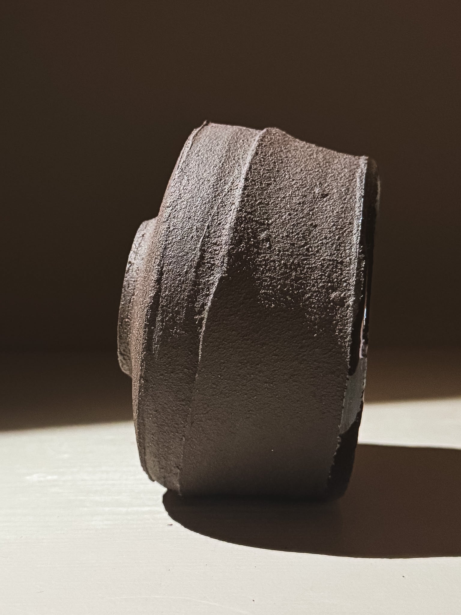 Kuro Matcha Bowl #09 side view showcasing textured dark brown slip finish and earthy tones.
