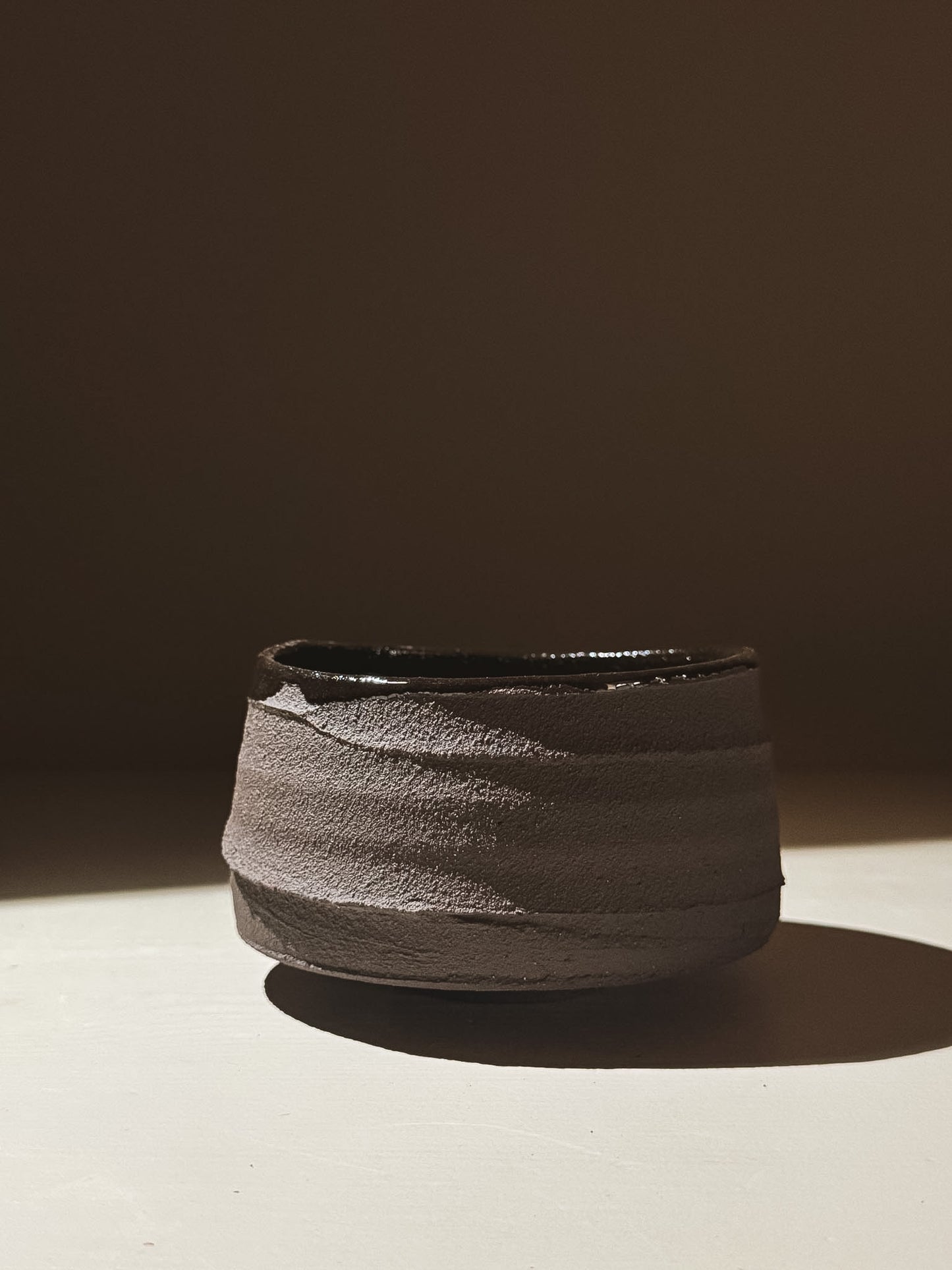 Kuro Matcha Bowl #10 with textured dark brown slip exterior and glossy dark glaze interior.