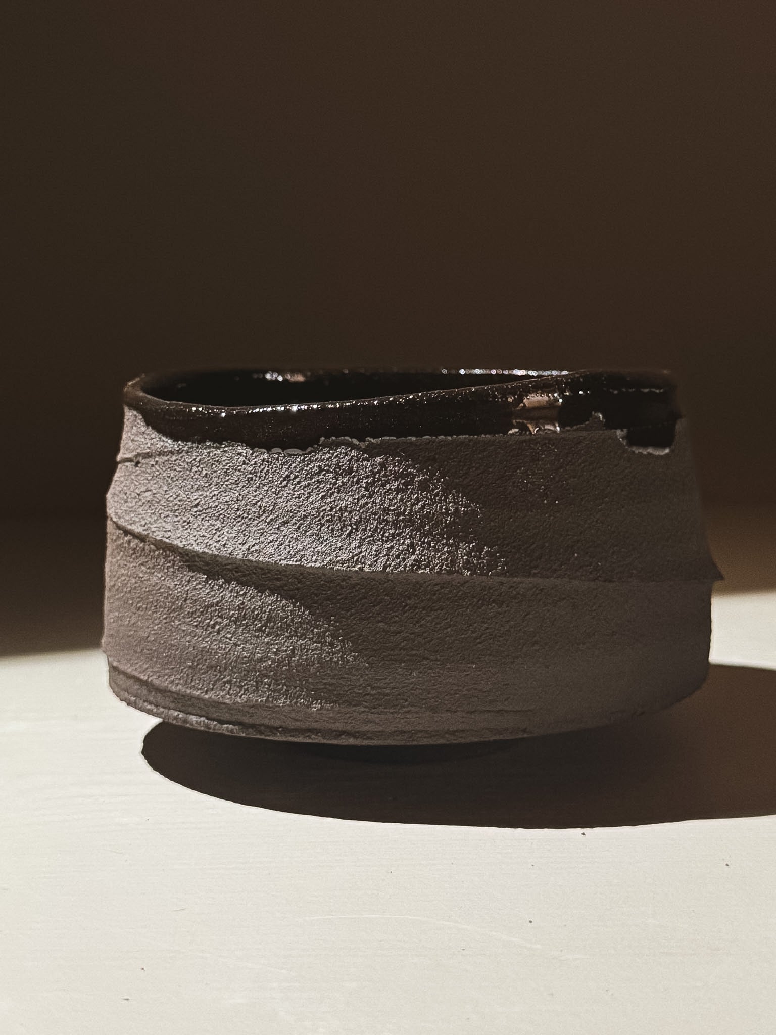 Kuro Matcha Bowl #10 with textured dark brown exterior and glossy interior, inspired by volcanic stone.