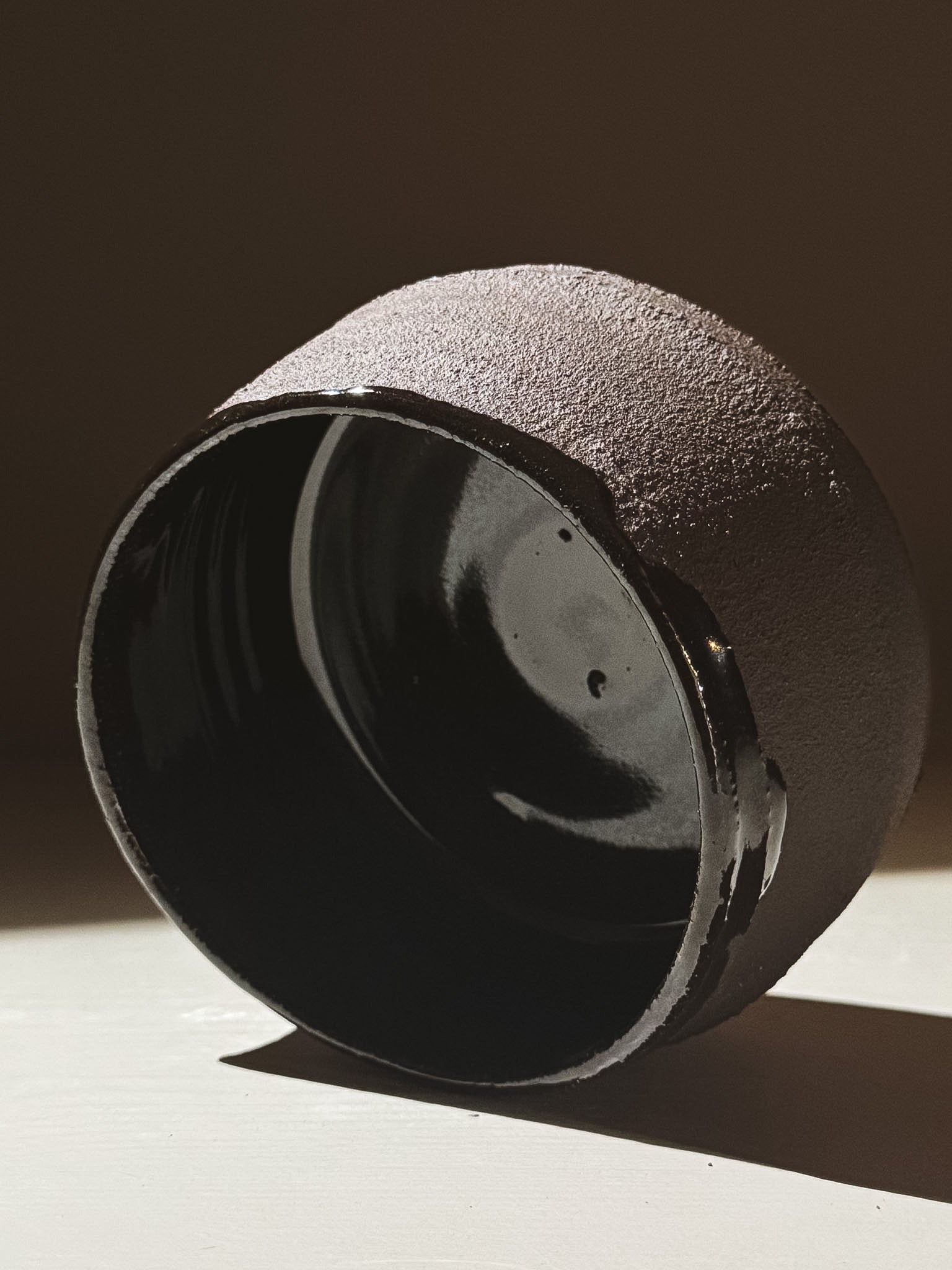 Kuro Matcha Bowl #10 showcasing its textured dark brown exterior and glossy interior glaze.