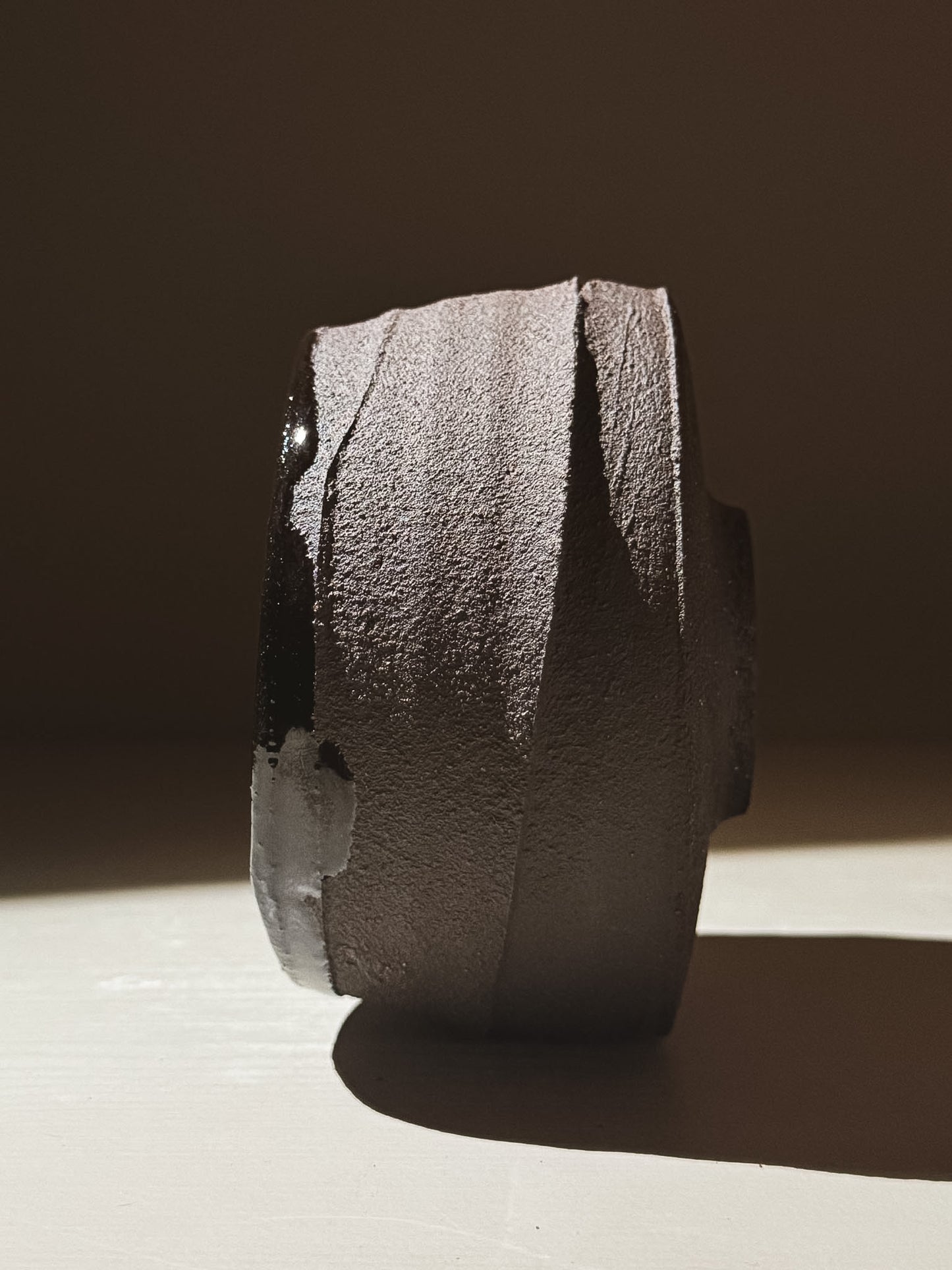 Kuro Matcha Bowl #10 showcasing volcanic stone-inspired textures in dark brown slip and glossy interior.