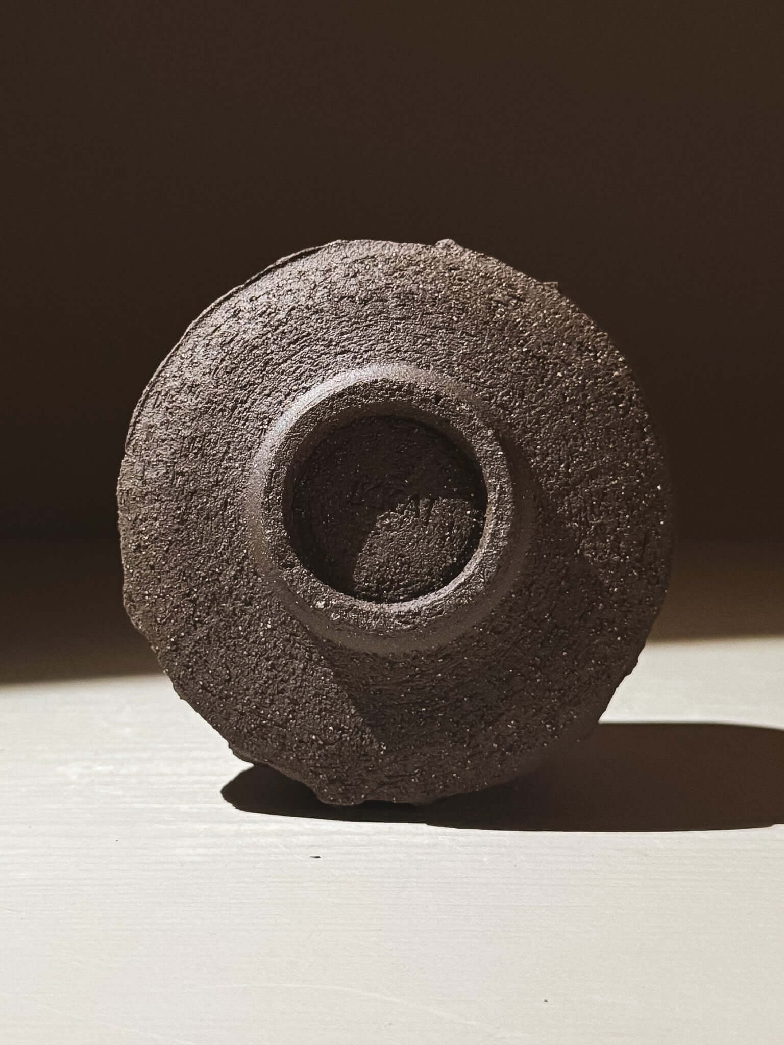 Yunomi Cup - Kuro #02 with a textured dark brown exterior, inspired by volcanic stone.