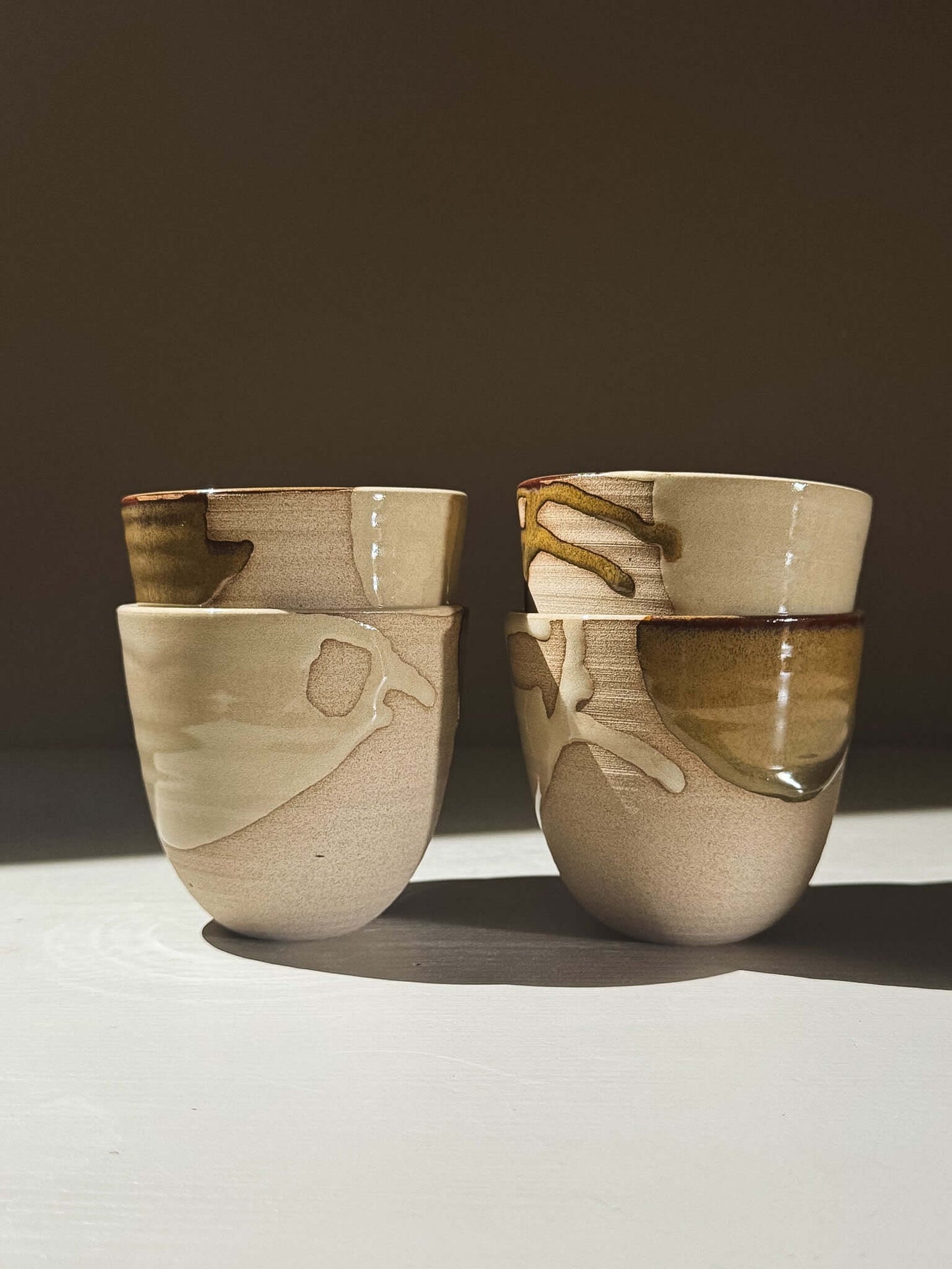 Stackable Latte Cups - Inyo arranged with a soft, handmade feel, showcasing flowing glazes and practical design.