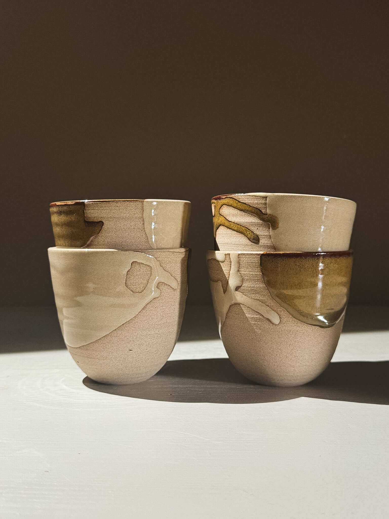 Stackable Latte Cups - Inyo arranged with a soft, handmade feel, showcasing flowing glazes and practical design.