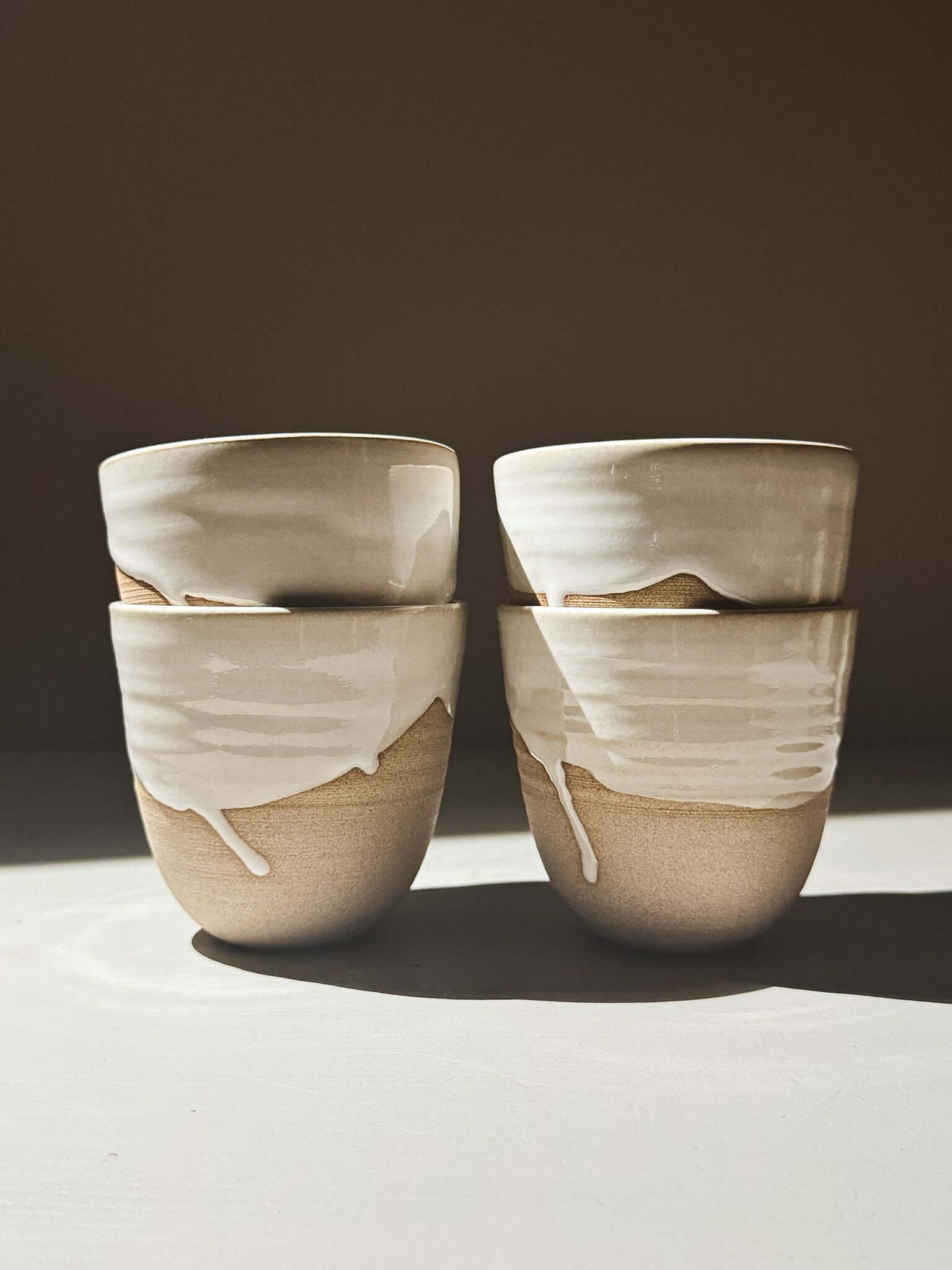 Stackable Latte Cups - Yuki, wheel-thrown ceramic cups with glossy white glaze and toffee clay base, perfect for stacking.