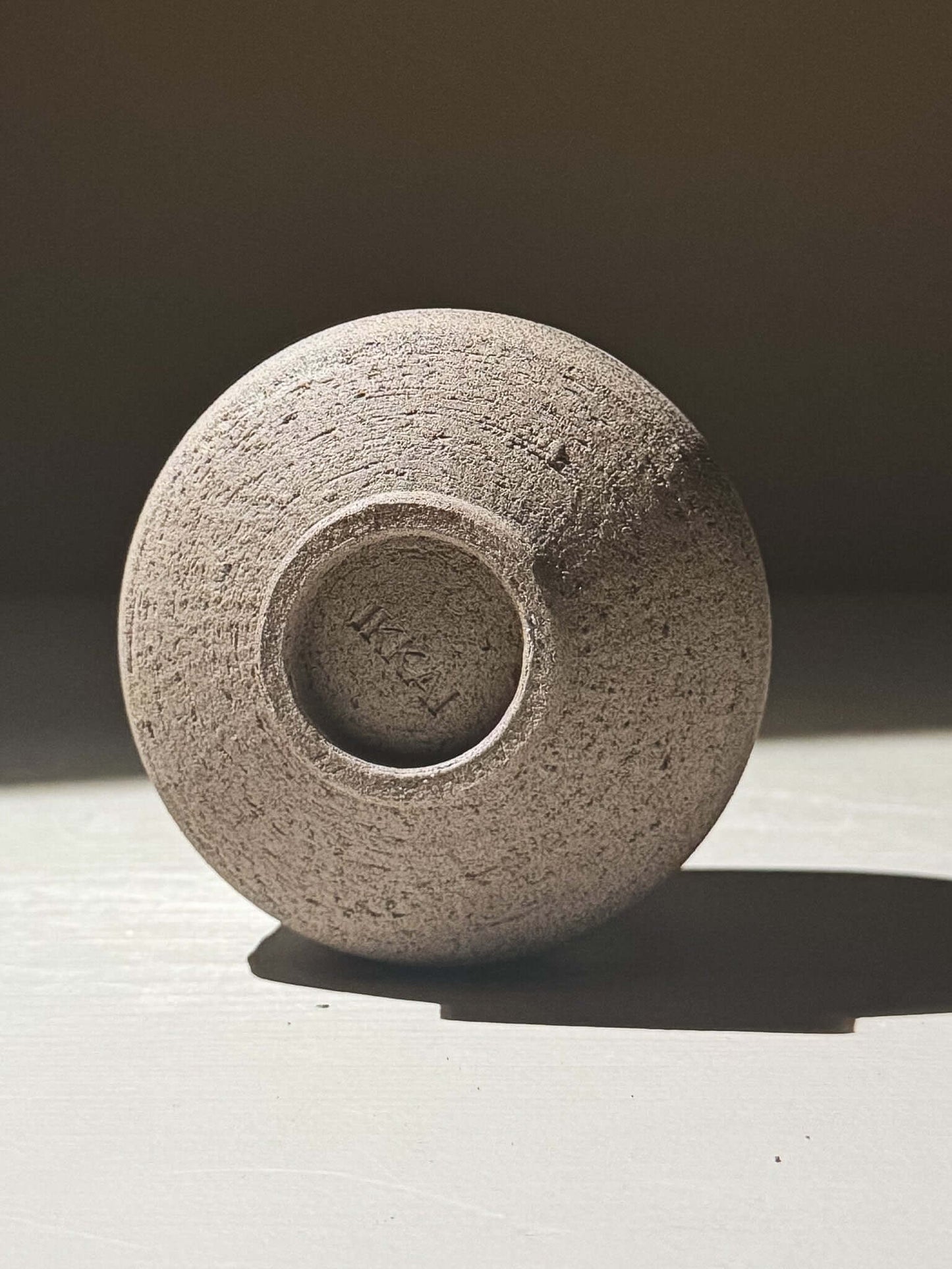 Yunomi Cup - Yuki Ash #03 showing the textured base and natural clay in soft light.