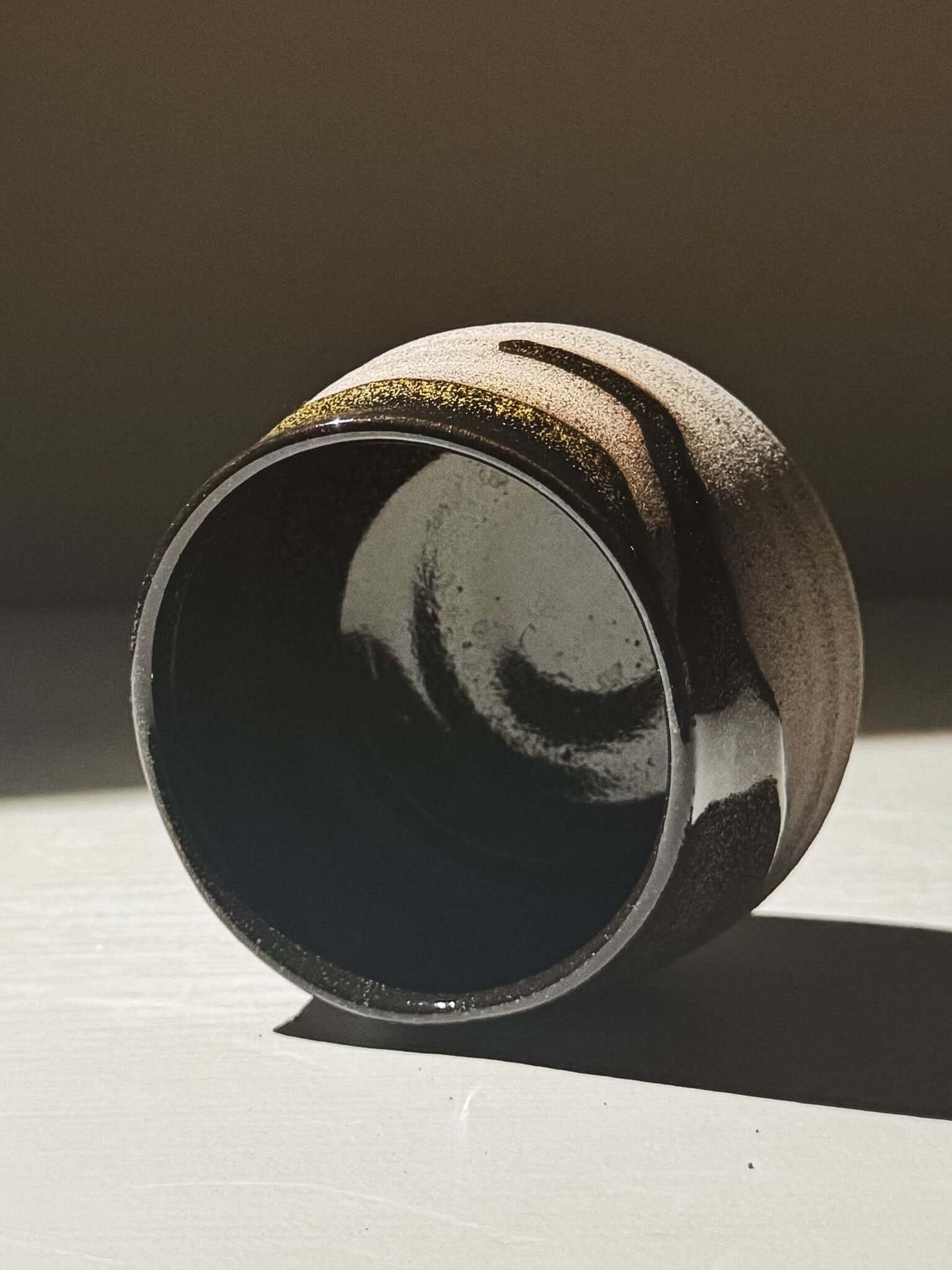 Yunomi Cup - Kuro Ash #01 with glossy black glaze and subtle golden speckles, showcasing handmade craftsmanship.