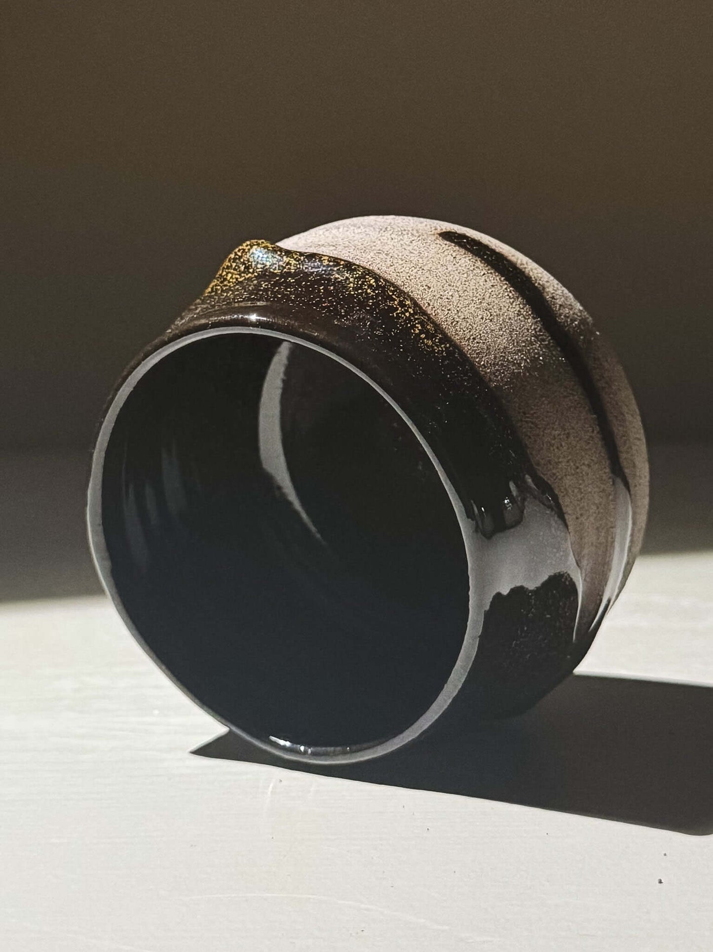 Yunomi Cup - Kuro Ash #03 showcasing glossy black glaze and subtle golden speckles.